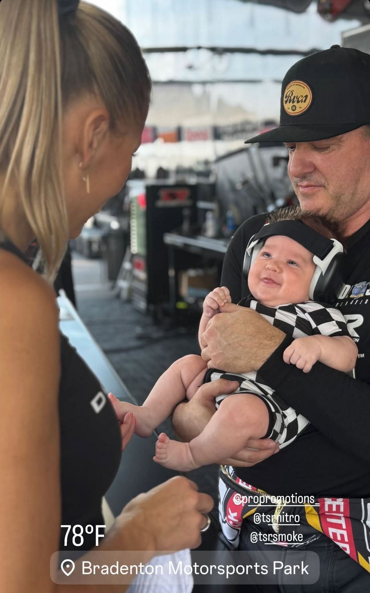 Screengrab of Leah Pruett&#039;s Instagram Story showing Tony Stewart holding their son Dominic wearing a race-inspired outfit.