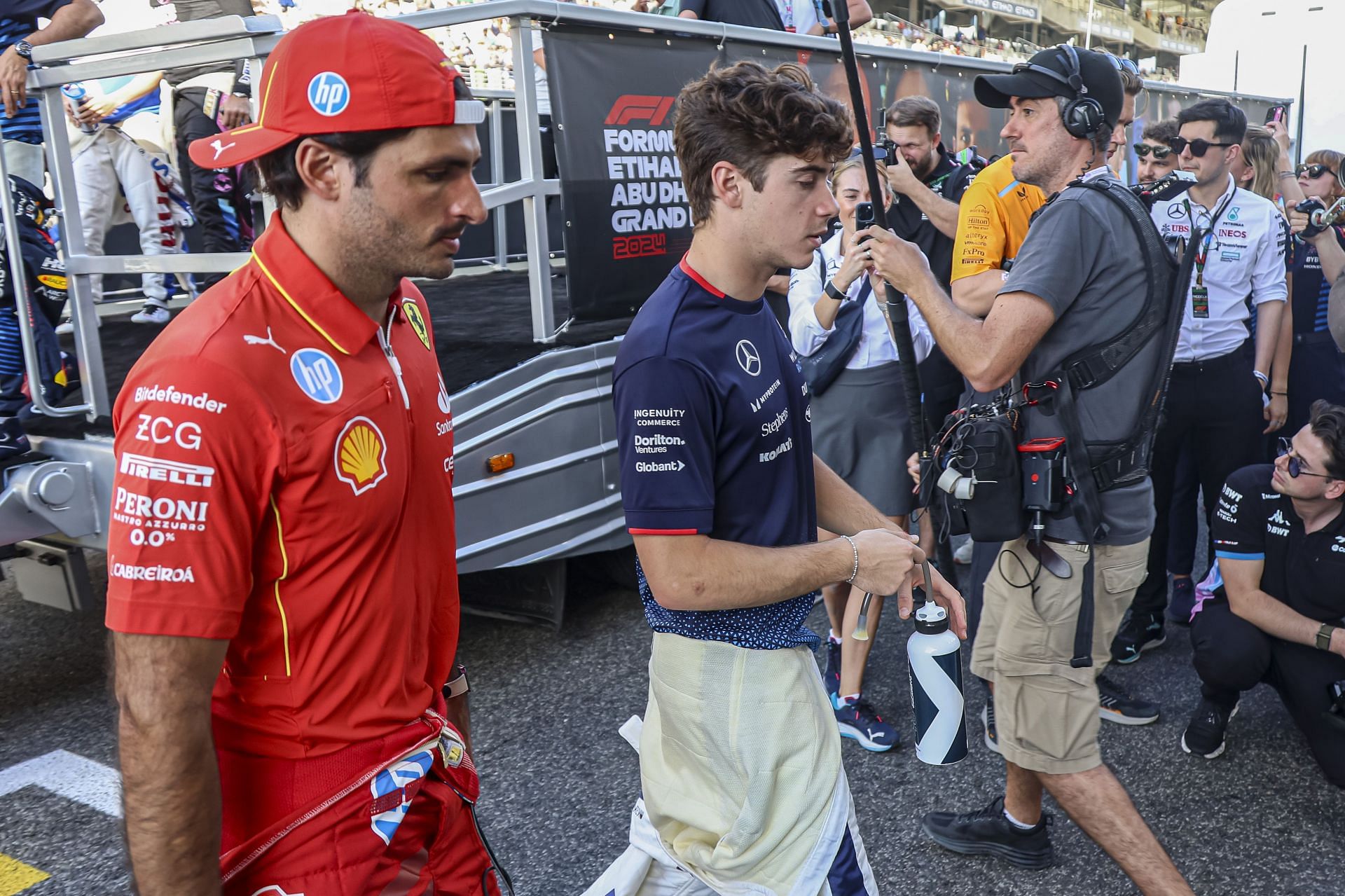 Franco Colapinto of Argentina driver of Williams Racing Formula One Team car FW46 no 43 with a Mercedes Power Unit Engine and Carlos Sainz of Ferrari spotted after drivers parade before the Abu Dhabi Grand Prix race in Yas Marina Circuit. Abu Dhabi, United Arab Emirates on December 8, 2024 (Photo by Nicolas Economou/NurPhoto via Getty Images) - Source: Getty