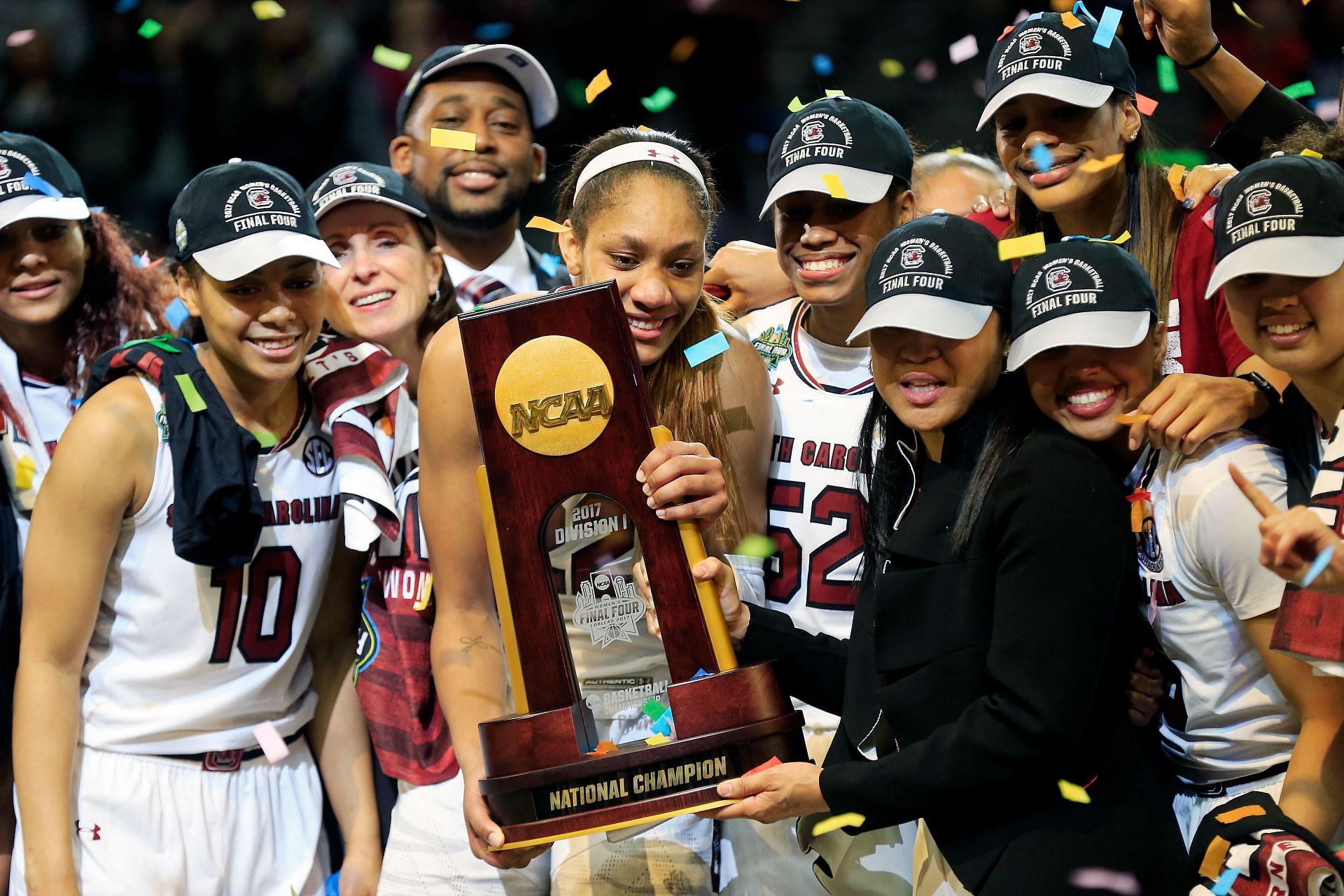 A&#039;ja Wilson (#22) and head coach Dawn Staley of the South Carolina Gamecocks hold the NCAA trophy and celebrate with their team after winning the championship game against the Mississippi State Lady Bulldogs on April 2, 2017 in Dallas, Texas. Photo: Getty