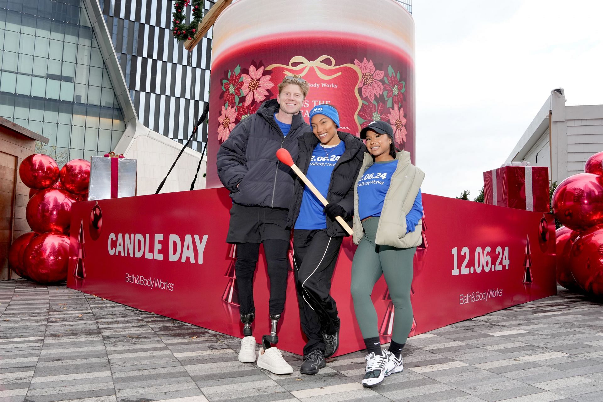 Hunter Woodhall and Tara Davis-Woodhall with American gymnast Jordan Chiles during an event (Image via: Getty Images)