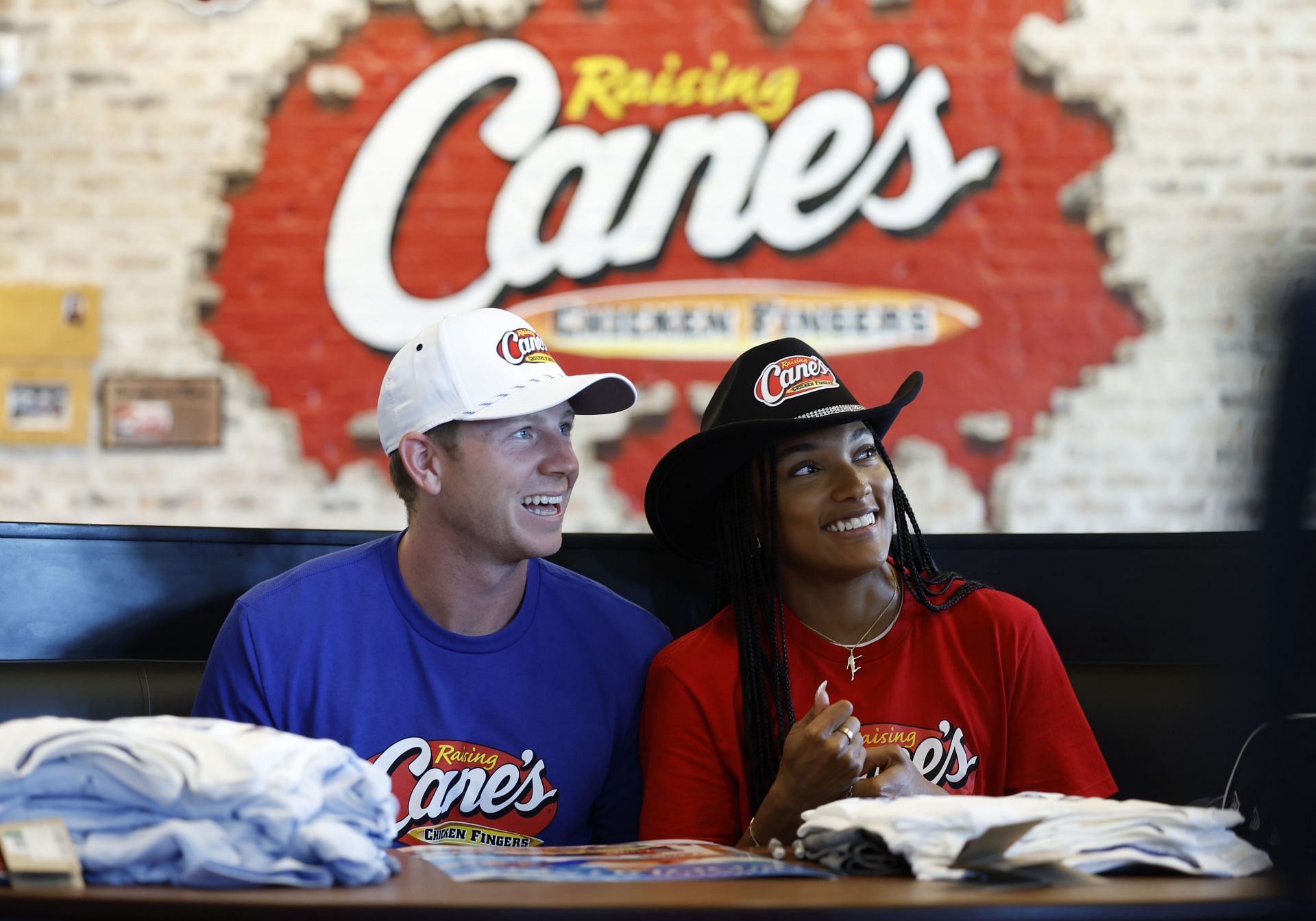 Paralympian Hunter Woodhall And Olympian Tara Davis-Woodhall Work Pre-Paris &quot;Shift&quot; At Raising Cane&#039;s - Source: Getty