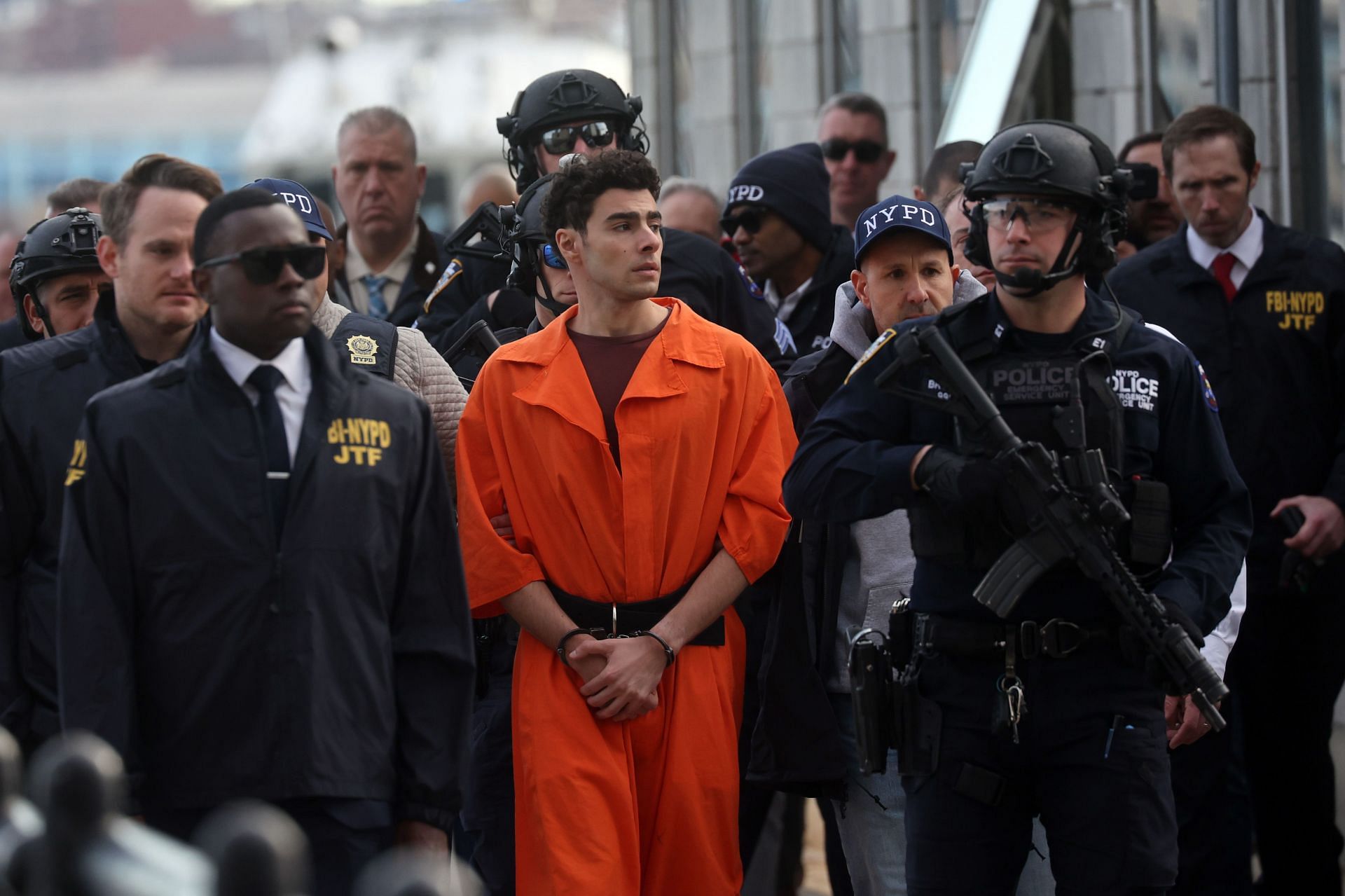 Luigi Mangione arrives at a heliport with members of the NYPD on December 19, 2024, in New York City (Photo by Spencer Platt/Getty Images)