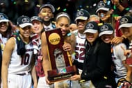 A'ja Wilson #22 and head coach Dawn Staley of the South Carolina Gamecocks hold the NCAA trophy and celebrate with their team after winning the 2017 championship game against the Mississippi State Lady Bulldogs (Photo: Getty)