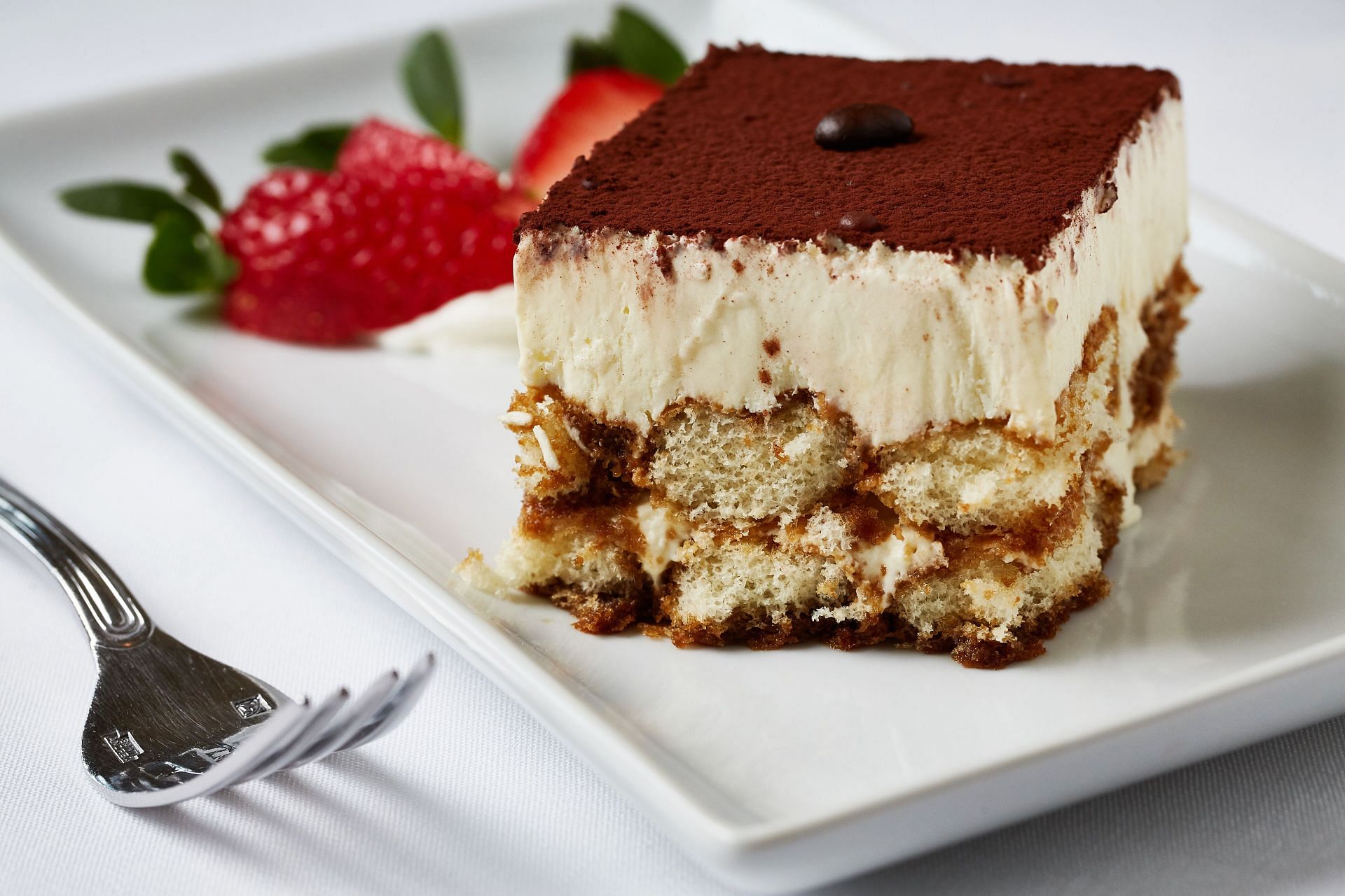 The Tiramisu Cheesecake has the flavors of a classic Tiramisu infused into a cheesecake (Image via Getty)