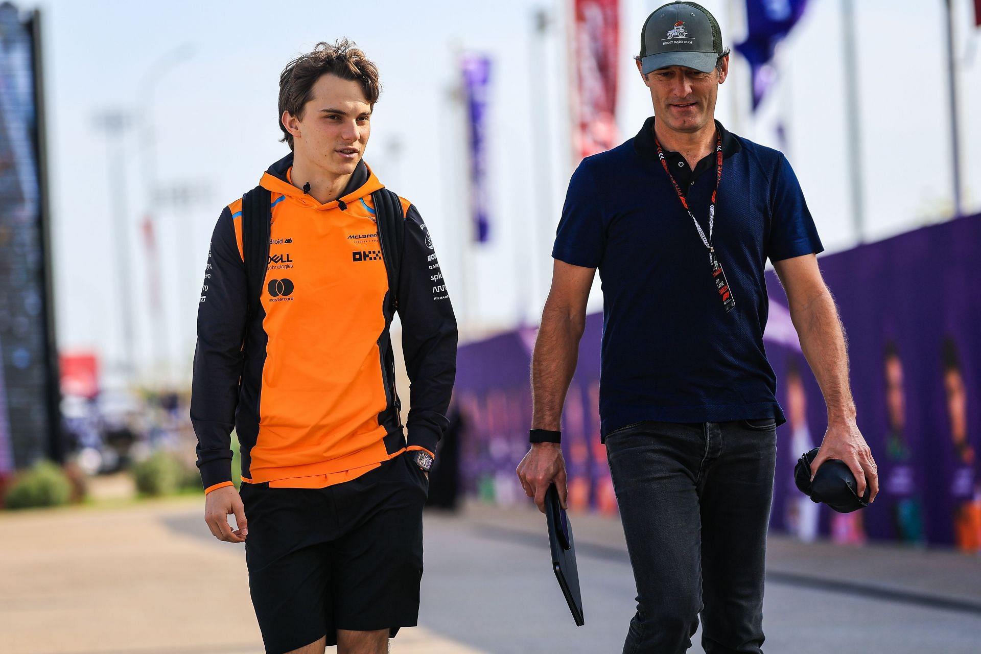 Oscar Piastri of Australia and McLaren walks with manager Mark Webber in the paddock - Source: Getty