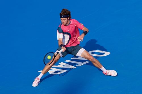 Andrey Rublev returns a ball against Alex De Minaur of Australia during day four of the Qatar ExxonMobil Open - Source: Getty