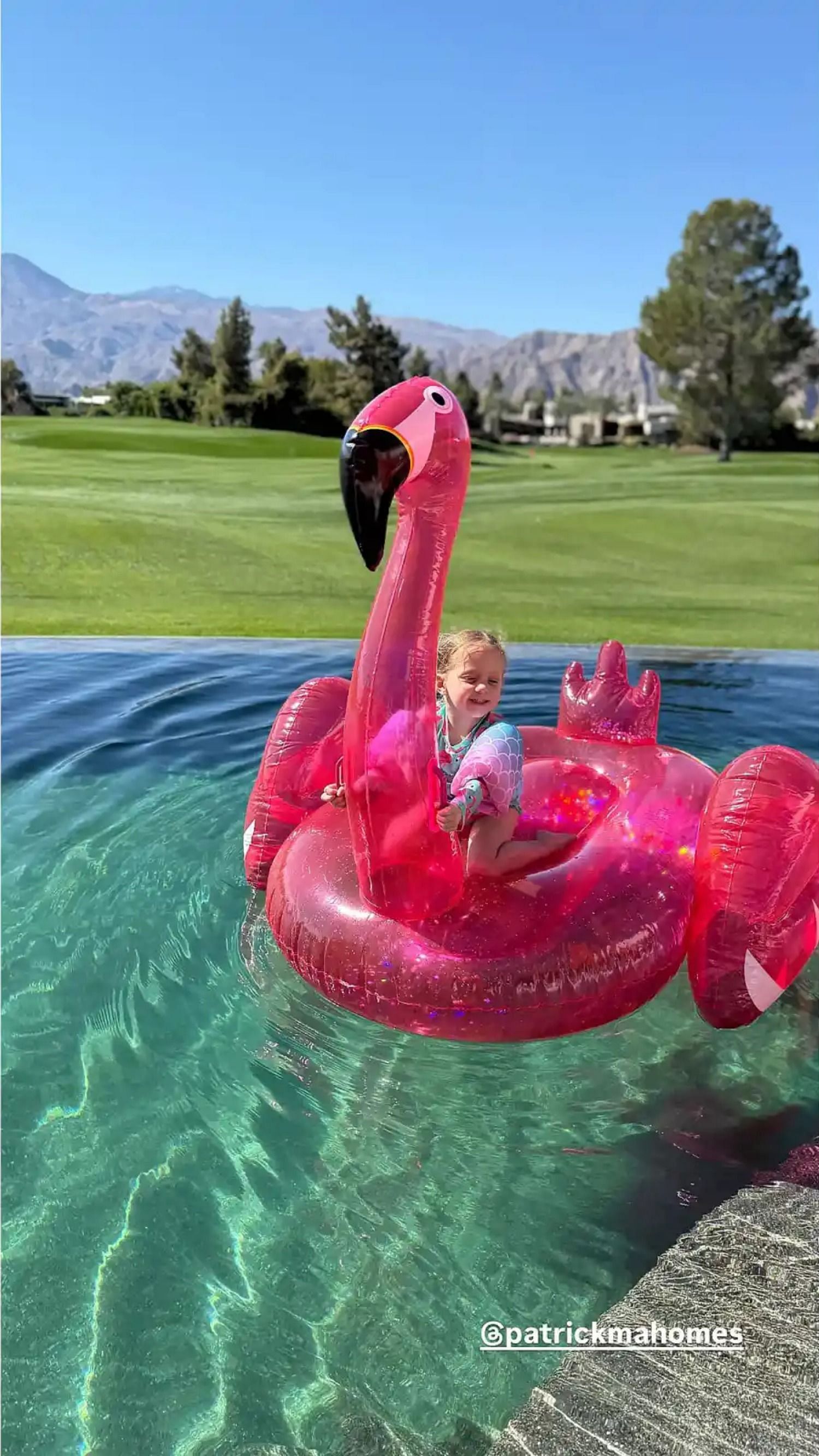 Sterling Skye Mahomes rides a flamingo in the family pool