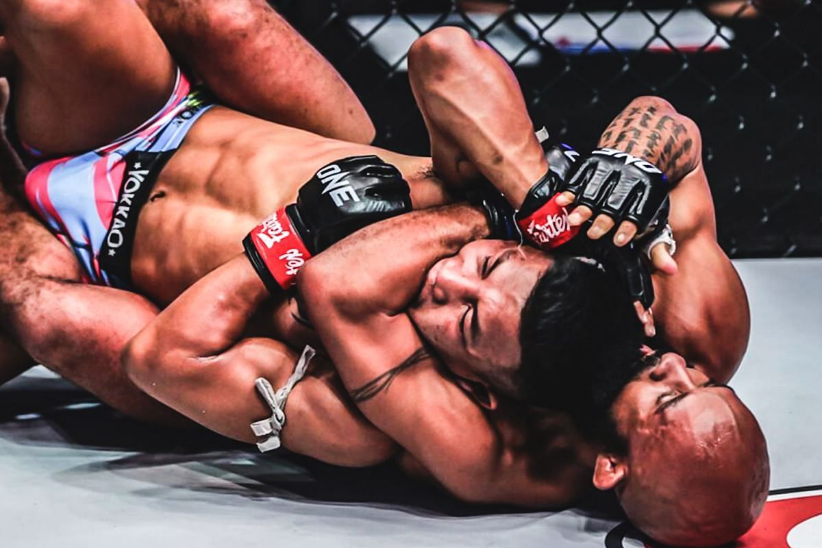 Demetrious Johnson showed Rodtang how to properly execute the rear-naked choke. [Photo via: ONE Championship]