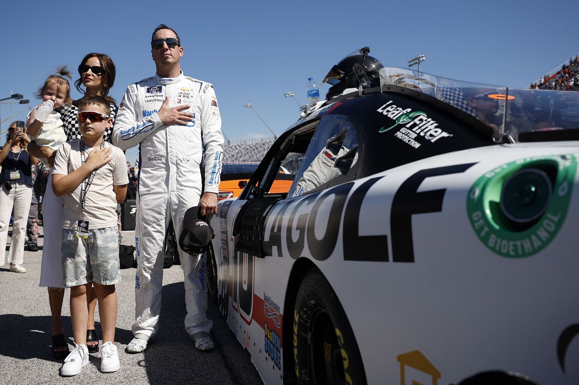 DARLINGTON, SOUTH CAROLINA - SEPTEMBER 02: Kyle Busch, driver of the #10 LA Golf Chevrolet, stands on the grid with his wife, Samantha Busch, daughter, Lennix Busch and son, Brexton Busch on the grid during the national anthem prior to the NASCAR Xfinity Series Sport Clips Haircuts VFW Help A Hero 200 at Darlington Raceway on September 02, 2023 in Darlington, South Carolina. (Photo by James Gilbert/Getty Images) - Source: Getty