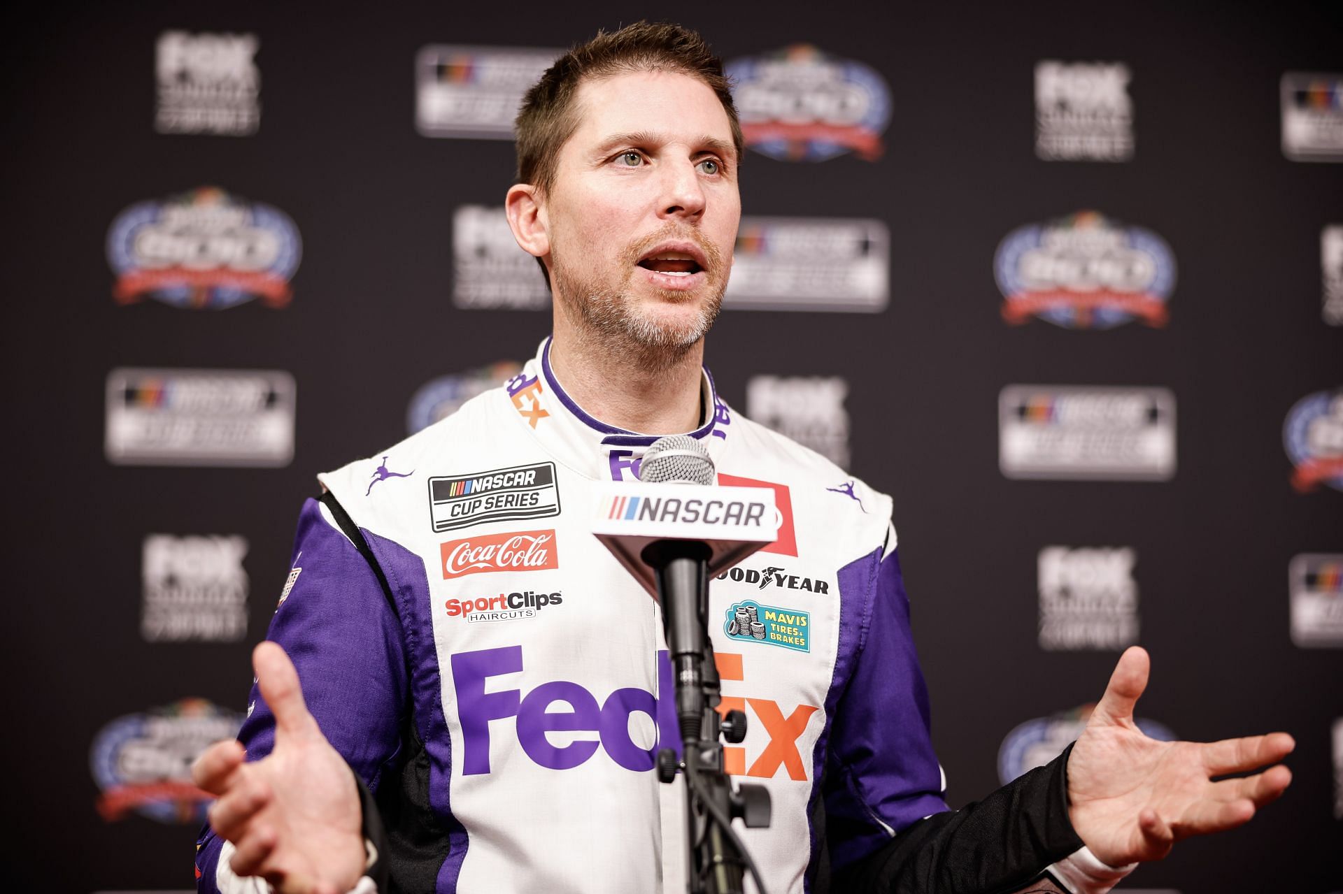 DAYTONA BEACH, FLORIDA - FEBRUARY 14: Denny Hamlin speaks to the Media during the NASCAR Cup Series 66th Annual Daytona 500 Media Day at Daytona International Speedway on February 14, 2024 in Daytona Beach, Florida. (Photo by James Gilbert/Getty Images) - Source: Getty