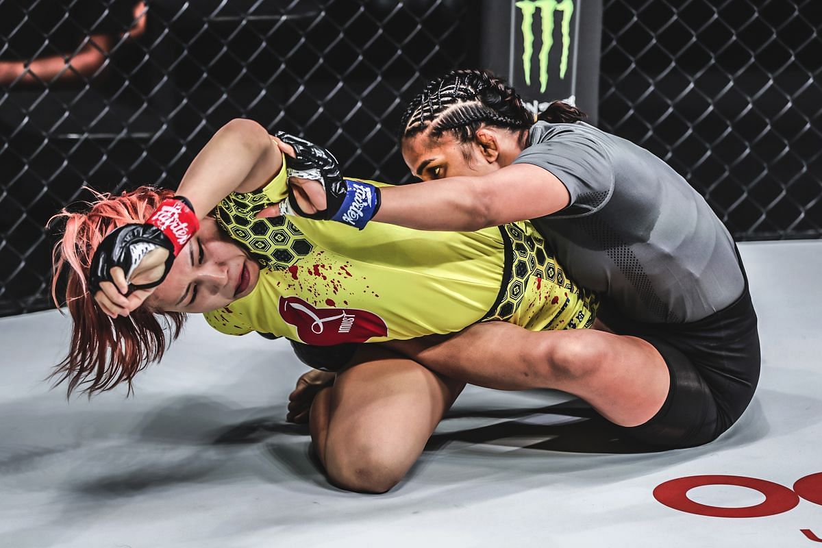 Ayaka Miura (in yellow) submits Ritu Phogat with a kneebar [Photo via ONE Championship]