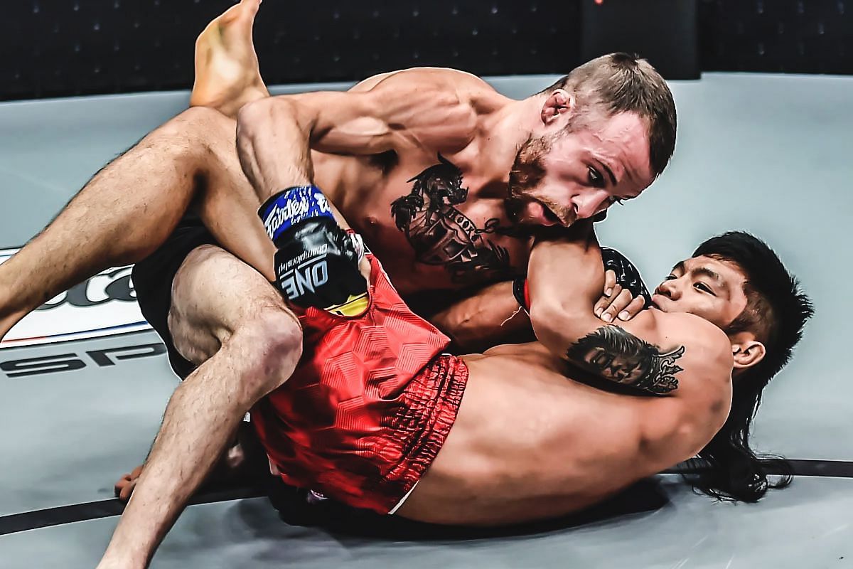 Jarred Brooks grappling with Lito Adiwang during thier November 2021 matchup. [Photo via: ONE Championship]