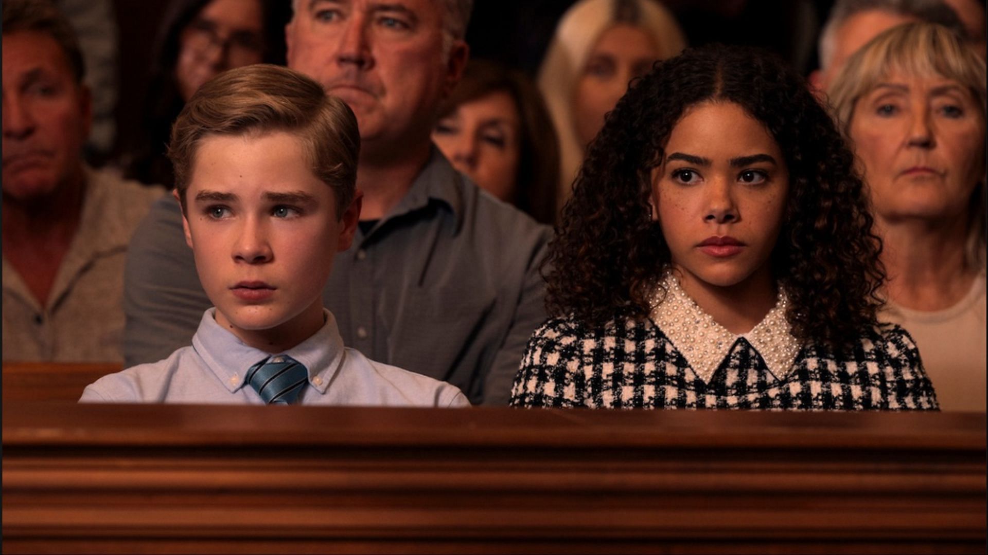 Austin and Ginny, played by Diesel La Torraca and Antonia Gentry, look on during a tense courtroom scene in Ginny &amp; Georgia season 3. (Image via Instagram/@briannehowey)