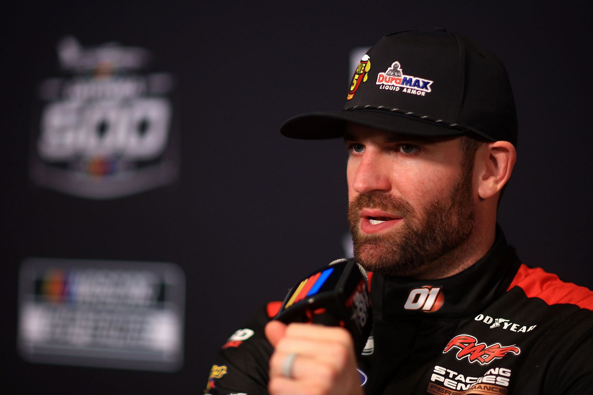 DAYTONA BEACH, FLORIDA - FEBRUARY 12: Corey LaJoie, driver of the #01 Take 5 Oil Change/DuraMax Ford speaks to the media during Media Day for the NASCAR Daytona 500 at Daytona International Speedway on February 12, 2025 in Daytona Beach, Florida. (Photo by Mike Ehrmann/Getty Images) - Source: Getty