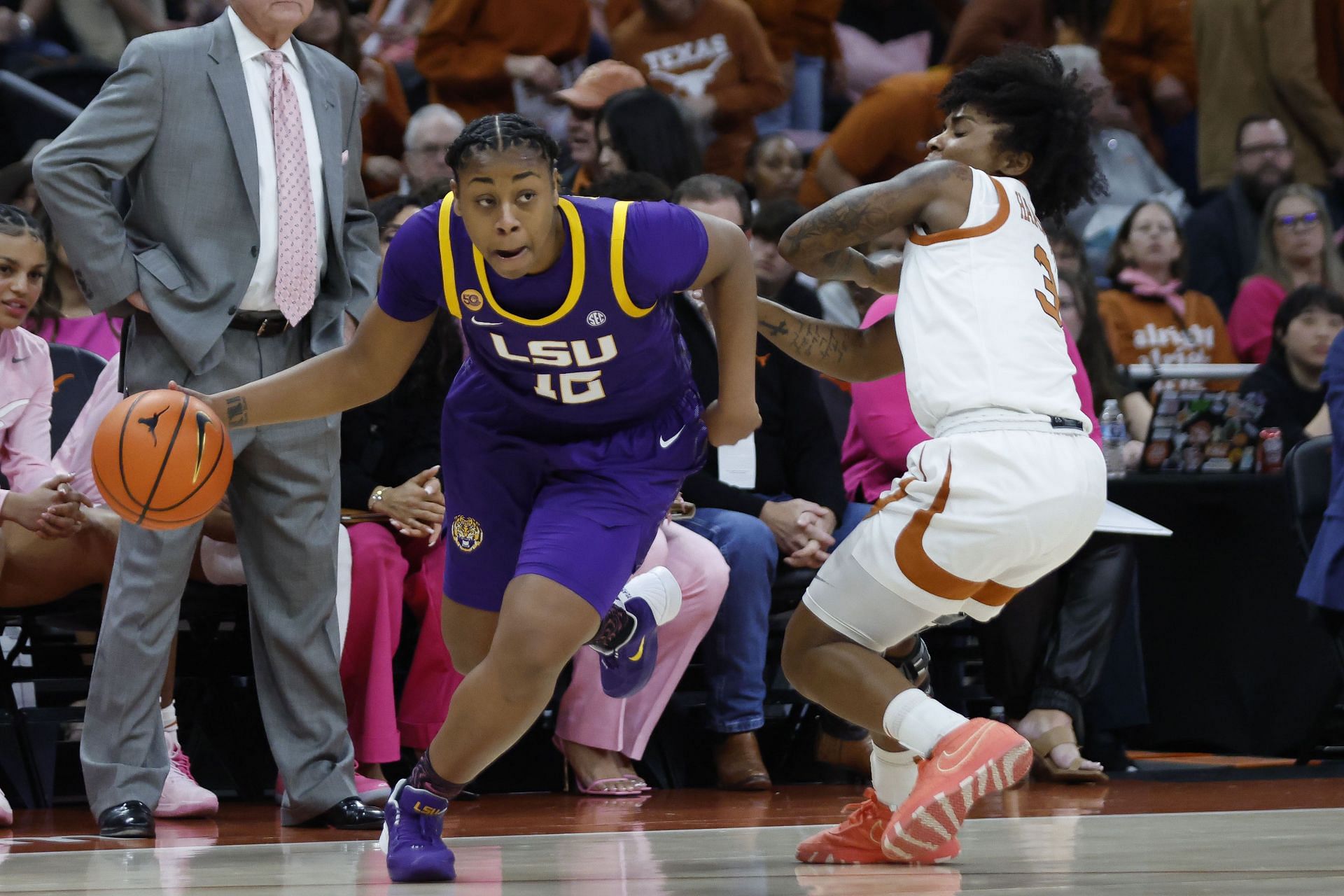 LSU Tigers guard Mikaylah Williams (#12) dribbles past Texas Longhorns guard Rori Harmon (3) during their game on February 16, 2025, at the Moody Center. Photo: Getty