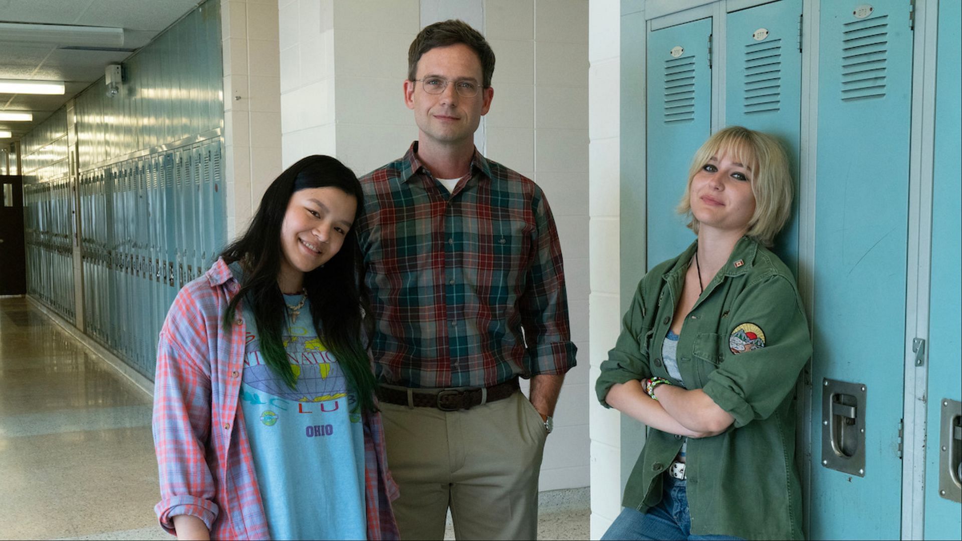 Cast members Sydney Topliffe, Patrick J. Adams, and Sarah Gadon in the hallways of the therapeutic boarding school featured in Wayward (Image Via Netflix Tudum)