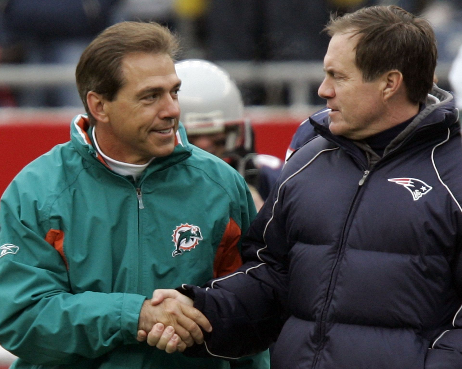 01 January 06: Miami Dolphins head coach Nick Saban, left, greets New England Patriots head coach Bill Belichick before the game at Gillette Stadium in Foxborough, MA. - Source: Getty