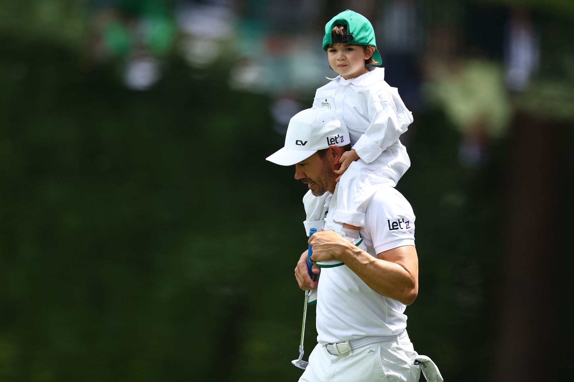 Camilo Villegas holds his son at the par 3 contest ahead of The Masters 2024 (via Getty)