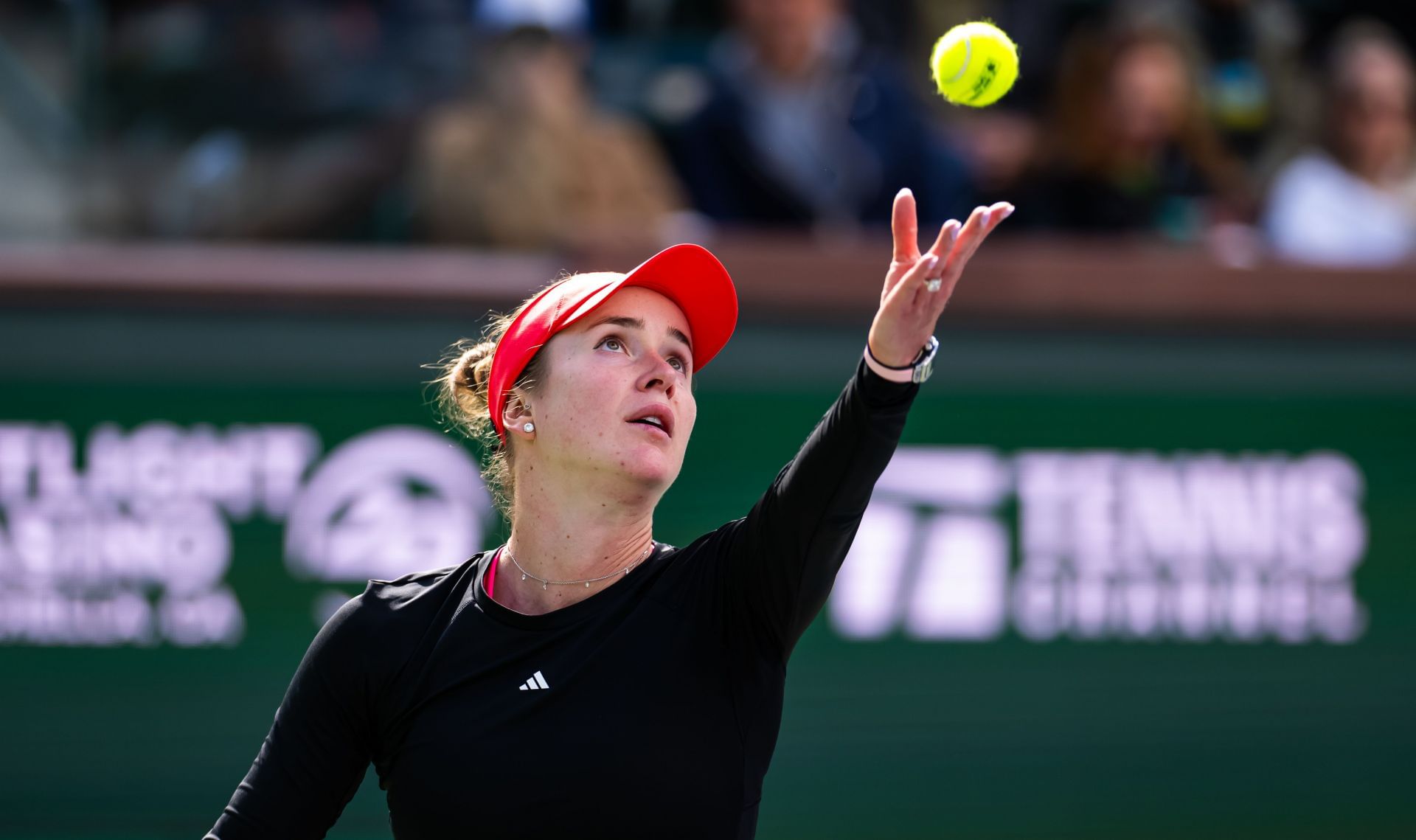 Svitolina tosses a ball to serve in the BNP Paribas Open - Source: Getty