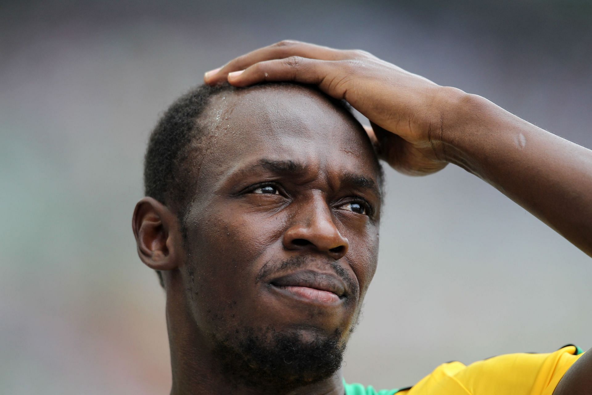 Usain Bolt looks on during the IAAF World Championships 2011 - (Source: Getty)