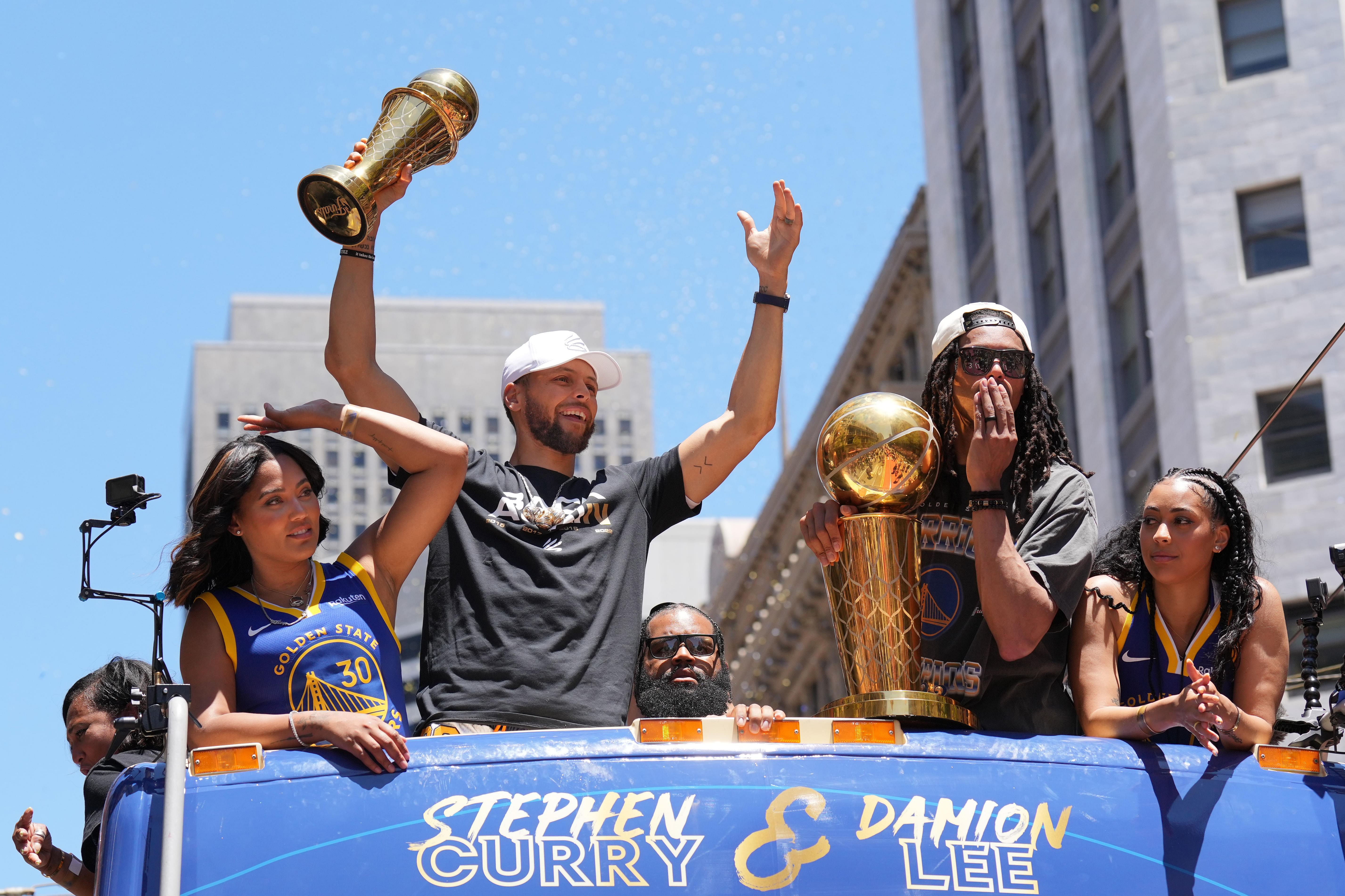 Golden State Warriors guard Stephen Curry gestures while standing with wife Ayesha, guard Damion Lee and his wife Sydel Curry in San Francisco. Photo Credit: Imagn