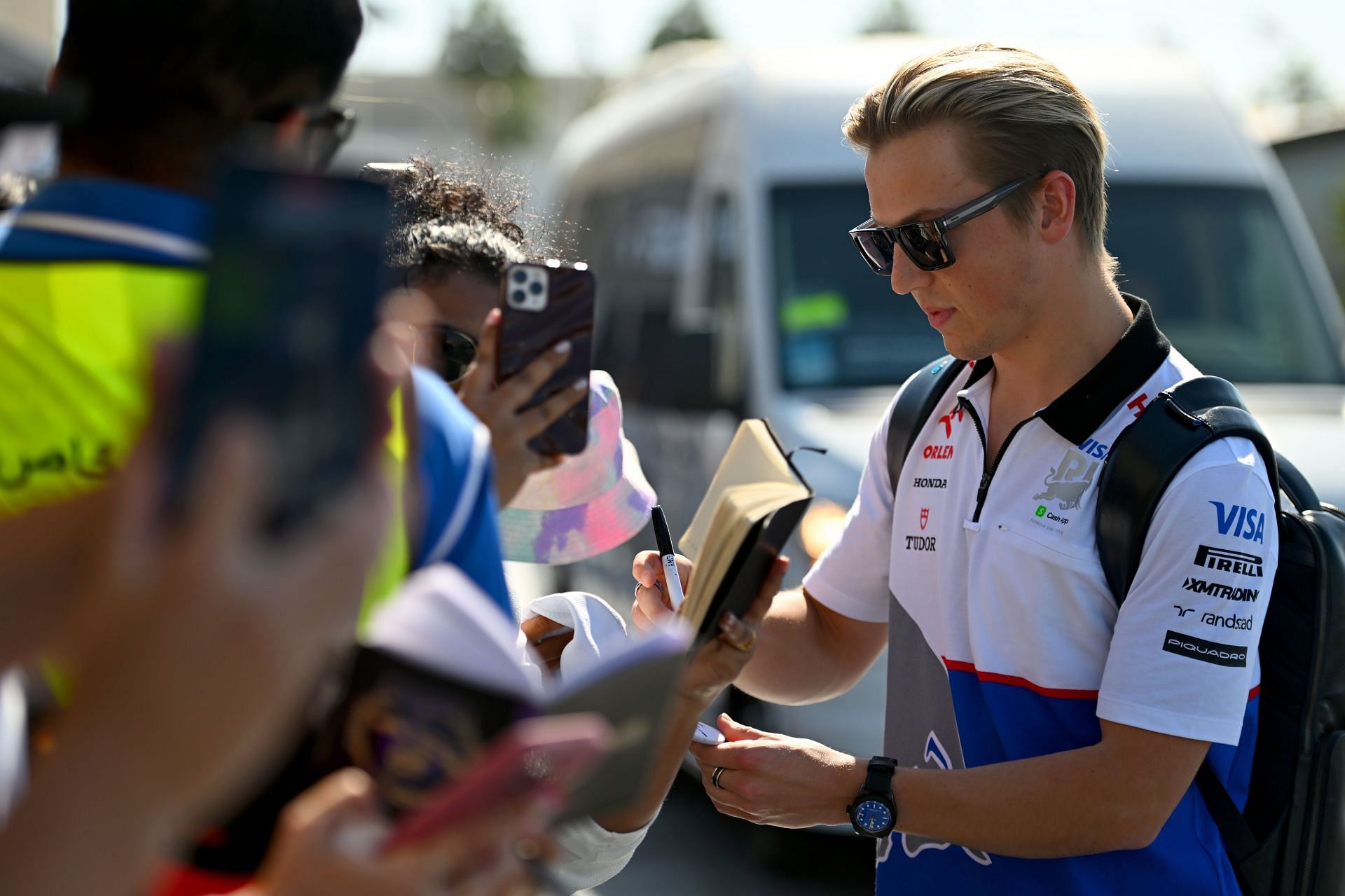 Liam Lawson of Visa Cash App RB greets fans as he arrives in the Paddock prior to the F1 Grand Prix of Abu Dhabi at Yas Marina Circuit on December 08, 2024 - Source: Getty