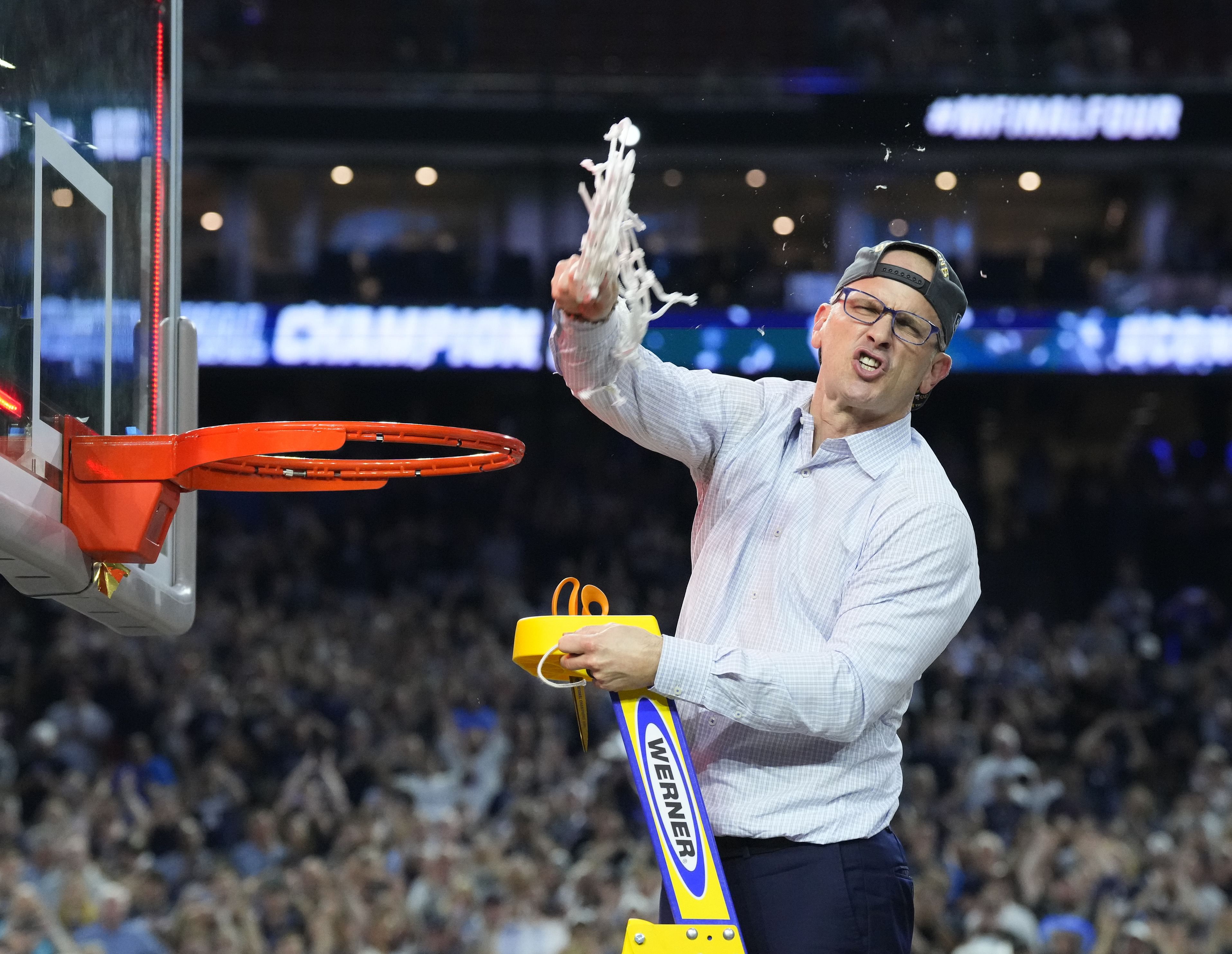 UConn Huskies head coach Dan Hurley cuts down the net after defeating the San Diego State Aztecs in the 2023 national championship game. Photo: Imagn