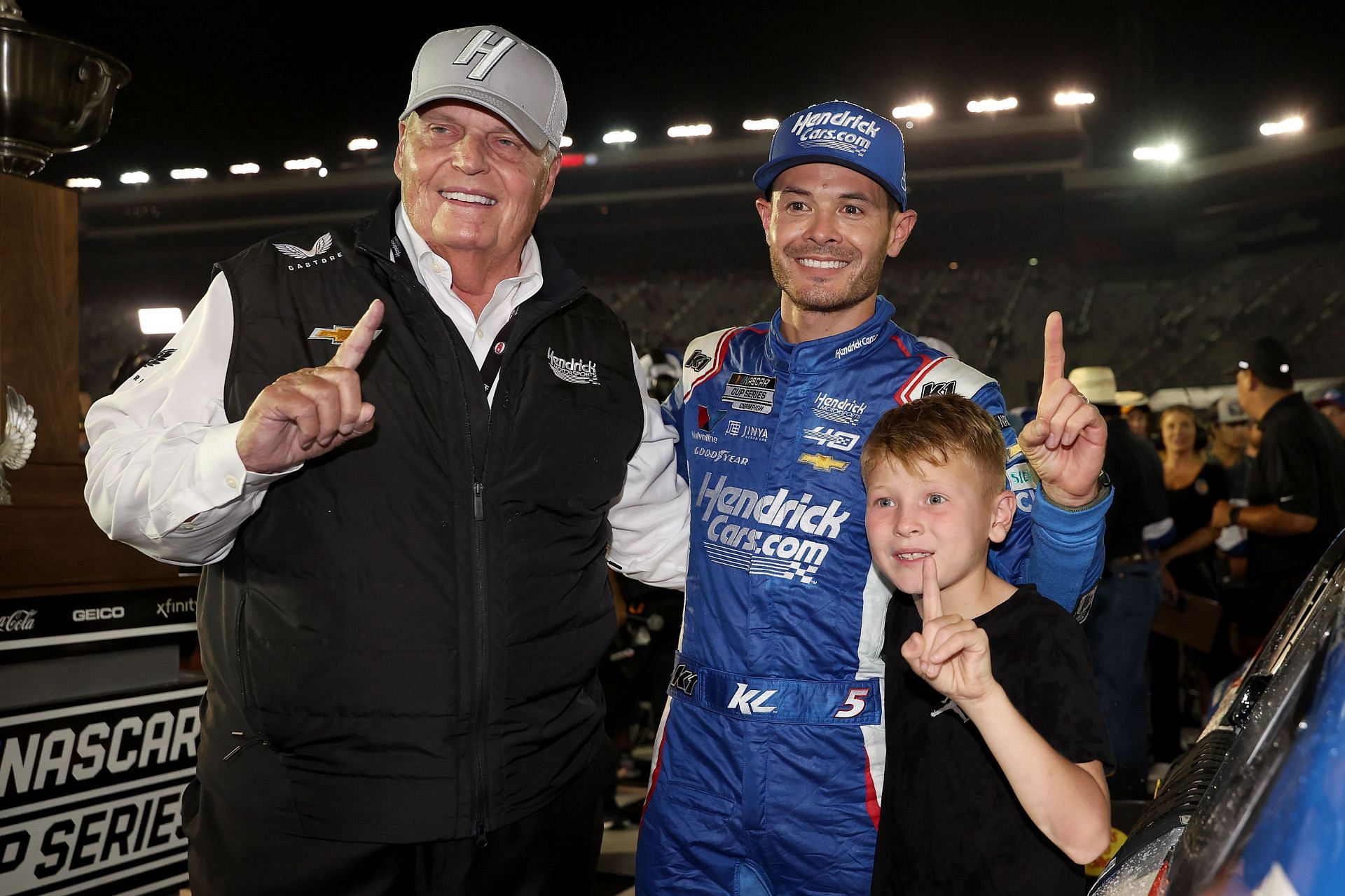 Rick Hendrick celebrates with Kyle Larson and his son, Owen Larson in victory lane after winning the NASCAR Cup Series Bass Pro Shops Night Race at Bristol Motor Speedway - Source: Getty