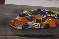 Kevin Harvick (21) dives below David Stremme during the Food City 250 - Source: Imagn