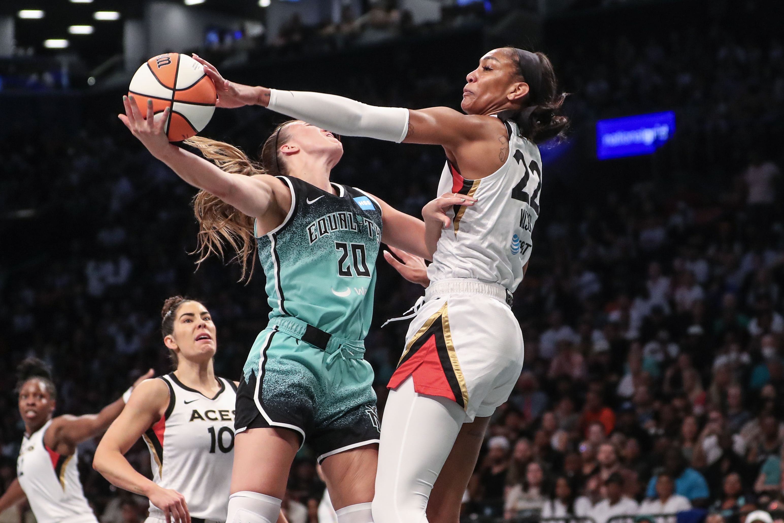 Las Vegas Aces forward A&#039;ja Wilson (#22) blocks a shot taken by New York Liberty guard Sabrina Ionescu (#20) in the first quarter at Barclays Center. Photo: Imagn