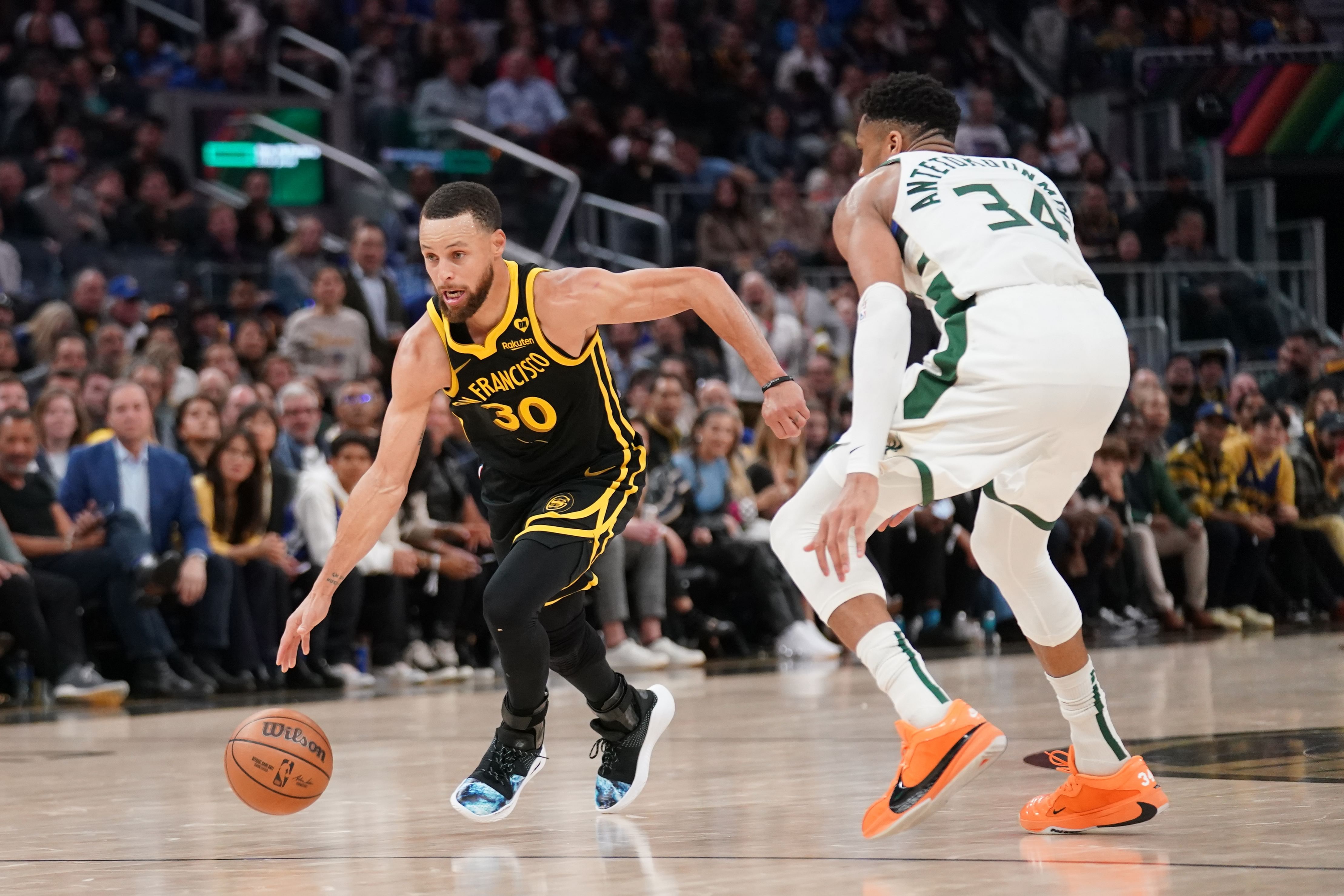 Golden State Warriors guard Stephen Curry dribbles past Milwaukee Bucks forward Giannis Antetokounmpo. Photo Credit: Imagn