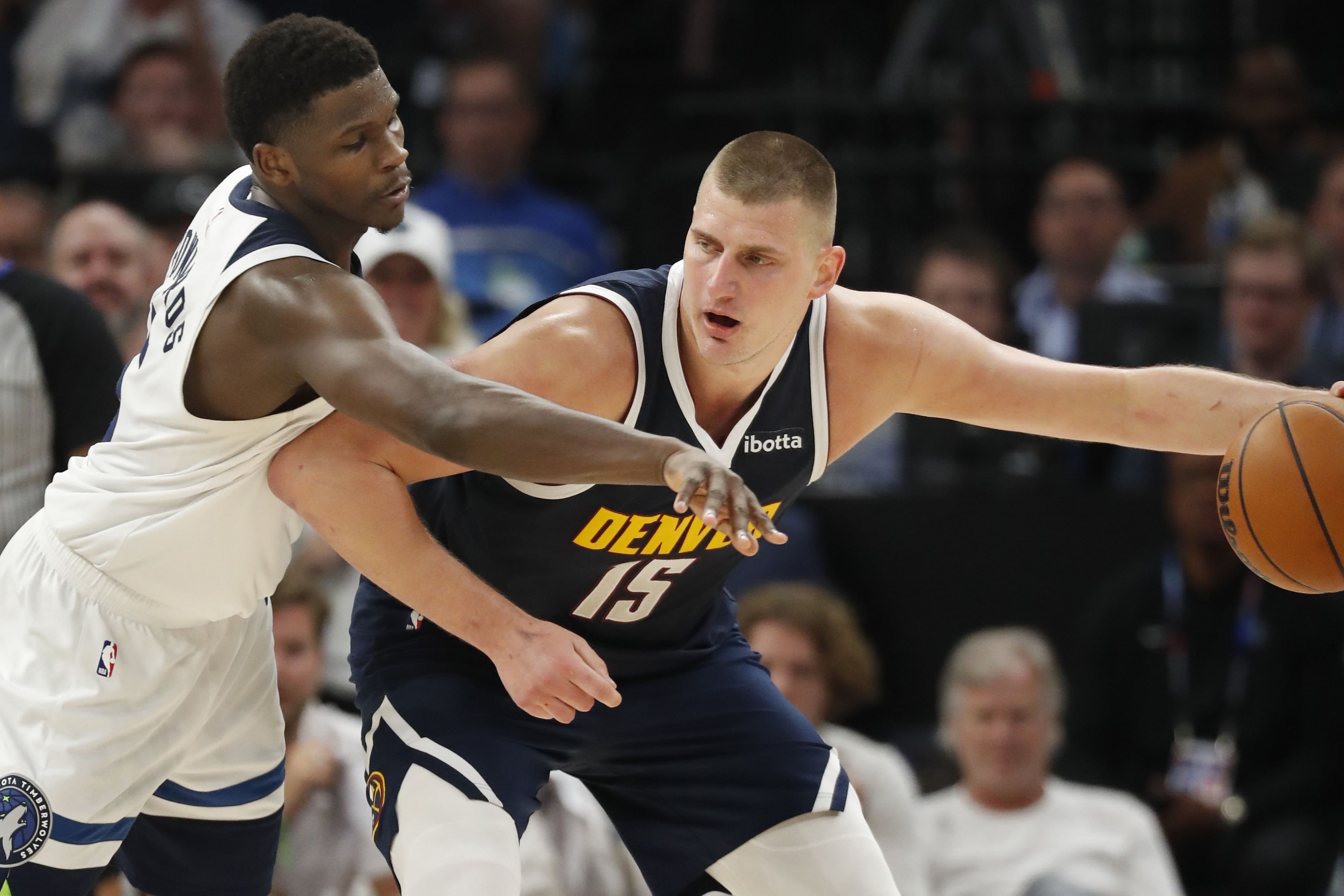 Denver Nuggets center Nikola Jokic works around Minnesota Timberwolves guard Anthony Edwards in the 2024 NBA playoffs at Target Center. Photo Credit: Imagn