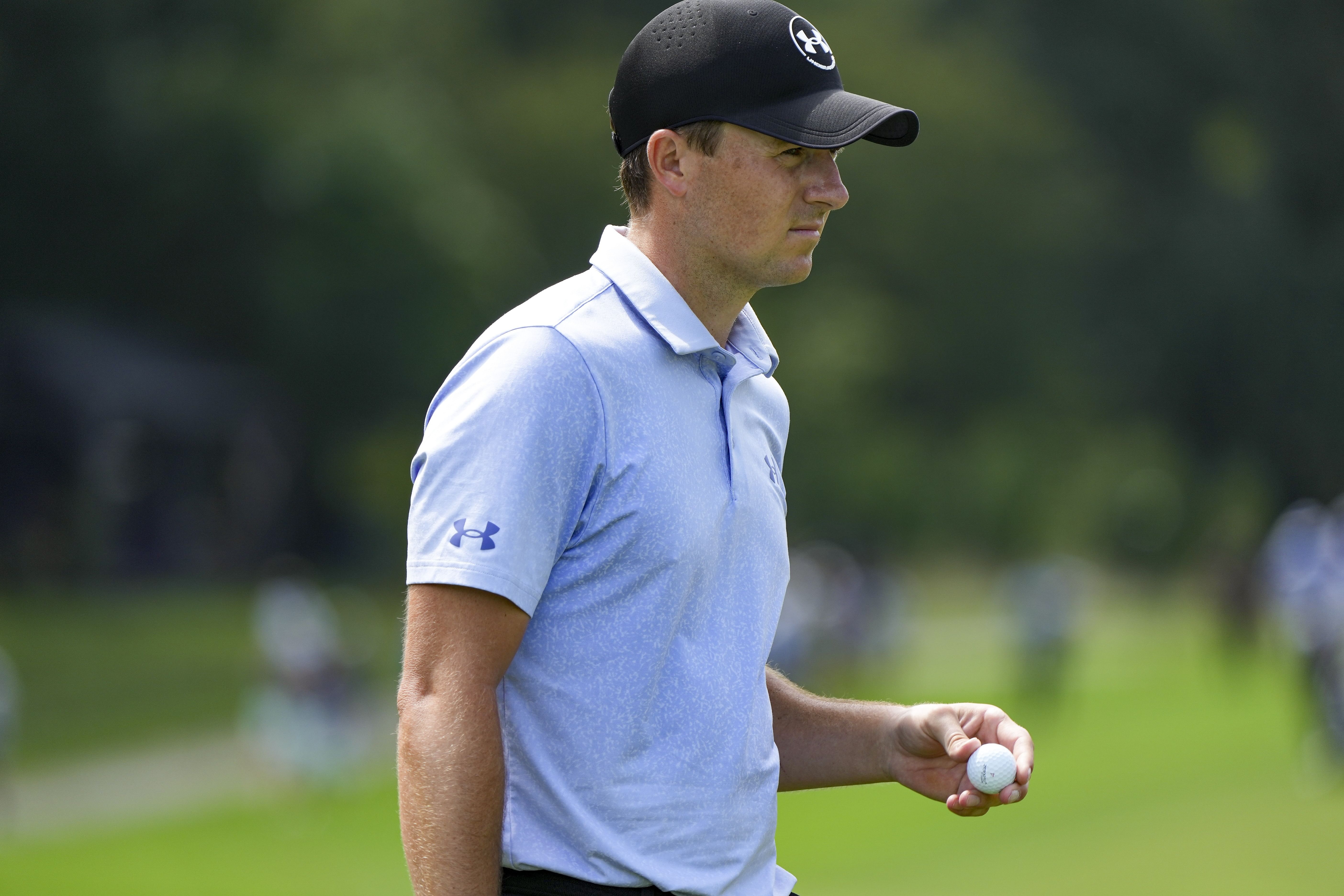 Jordan Spieth looks over his line on the 14th green during the first round of the 2024 Wyndham Championship golf tournament - Source: Imagn