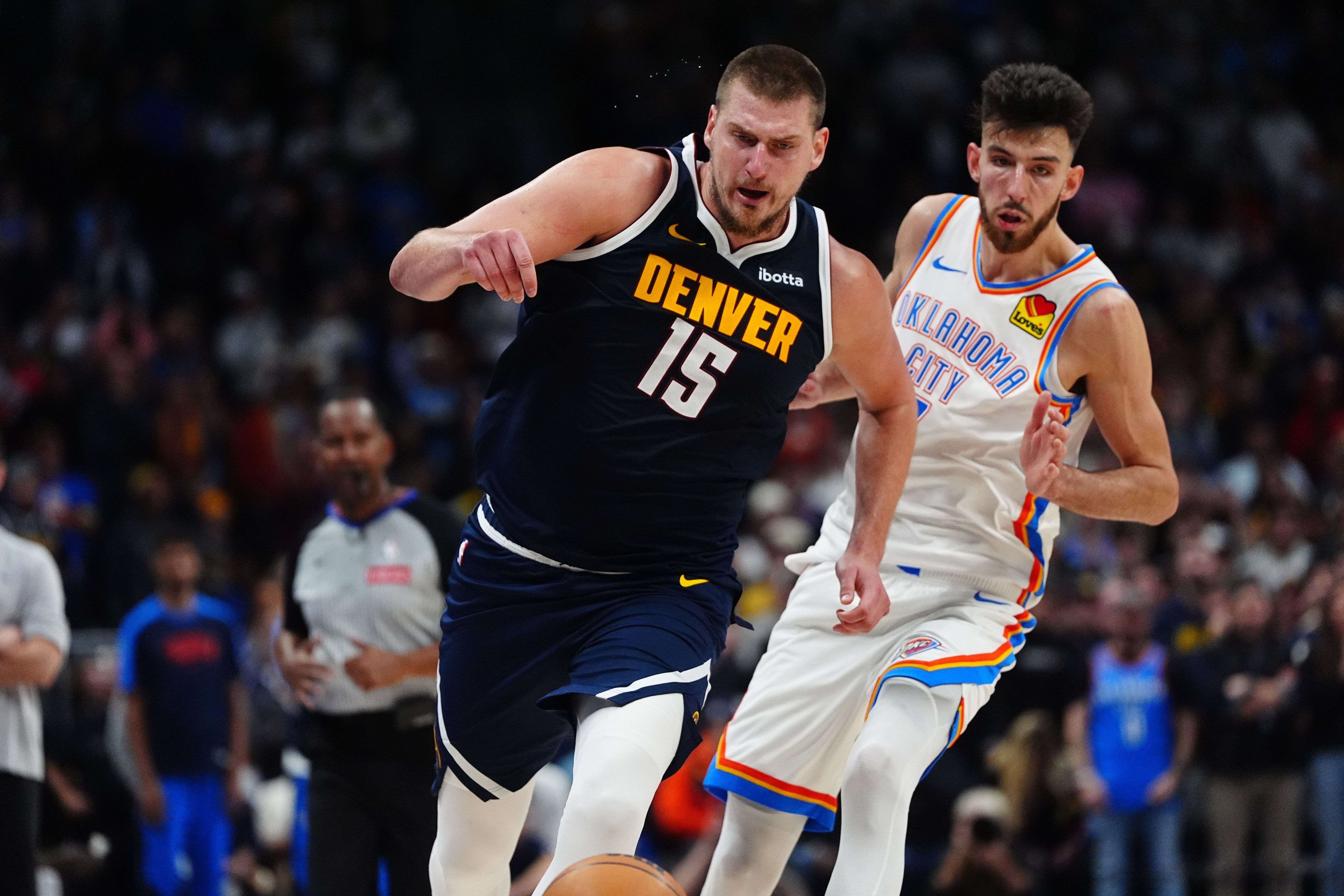 Denver Nuggets center Nikola Jokic drives past OKC Thunder forward Chet Holmgren at Ball Arena. Photo Credit: Imagn