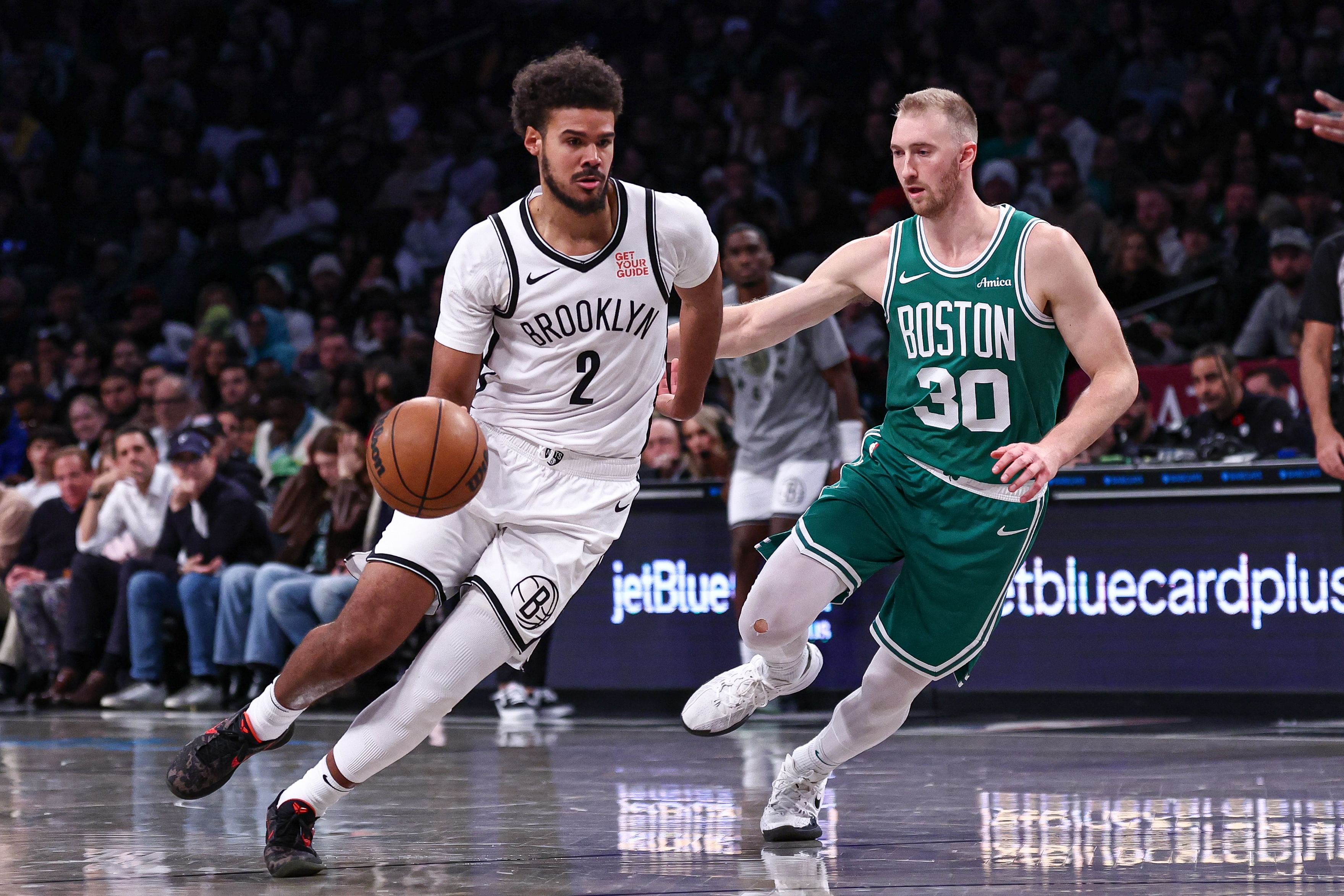 Brooklyn Nets forward Cameron Johnson dribbles as Boston Celtics forward Sam Hauser at Barclays Center. Photo Credit: Imagn