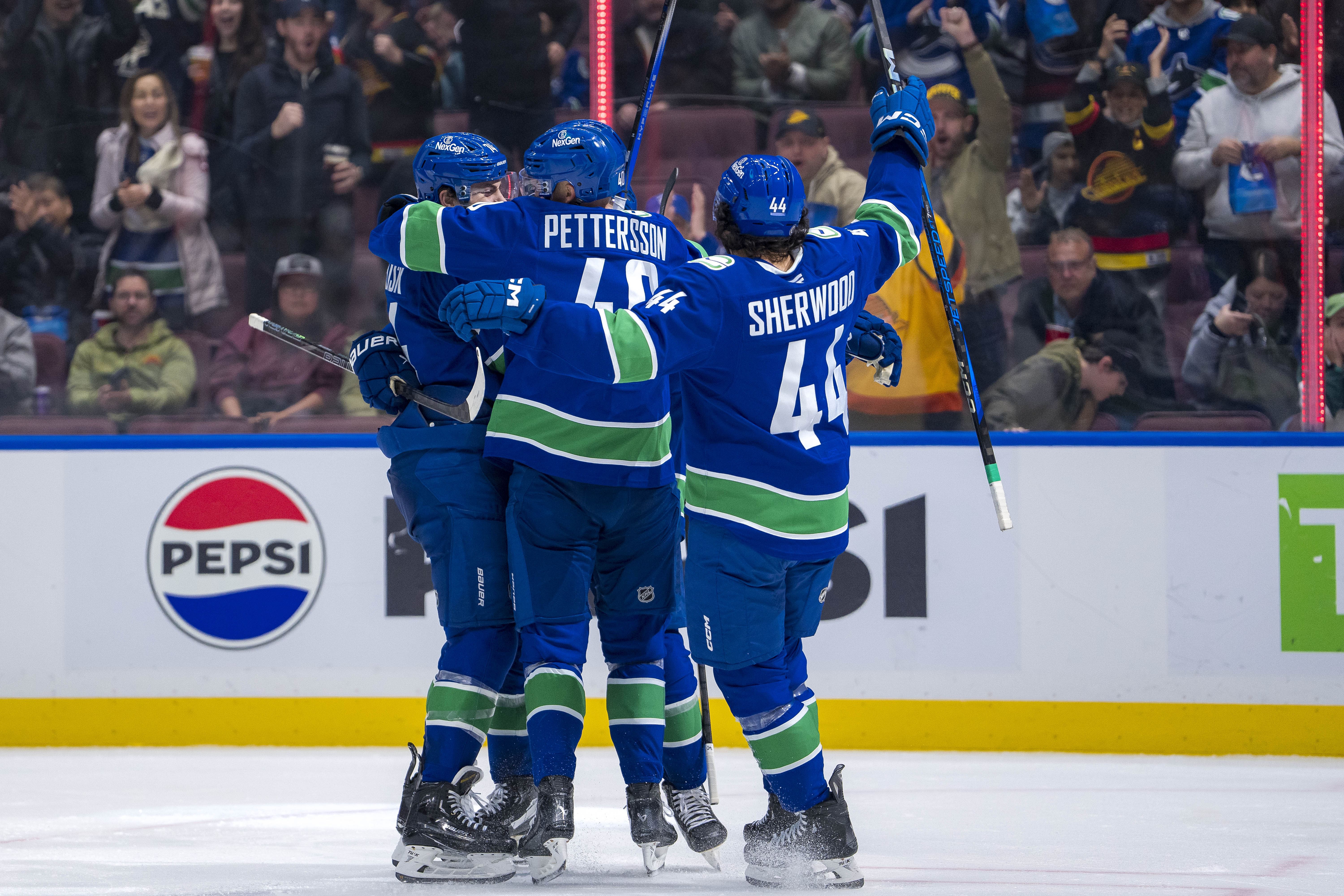 NHL: Canucks celebrate goals vs Blackhawks - Source: Imagn