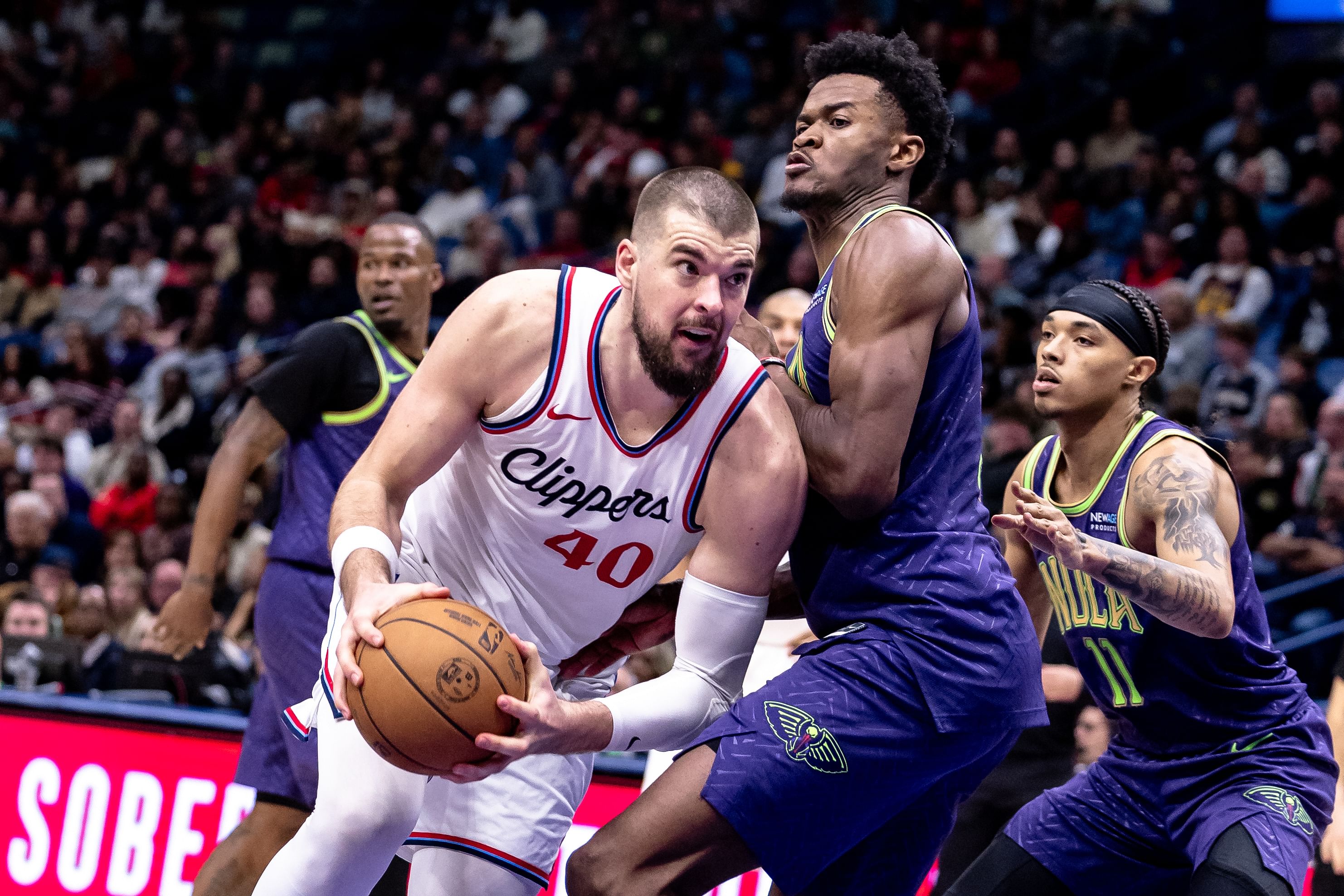 LA Clippers center Ivica Zubac dribbles against New Orleans Pelicans center Yves Missi at Smoothie King Center. Photo Credit: Imagn