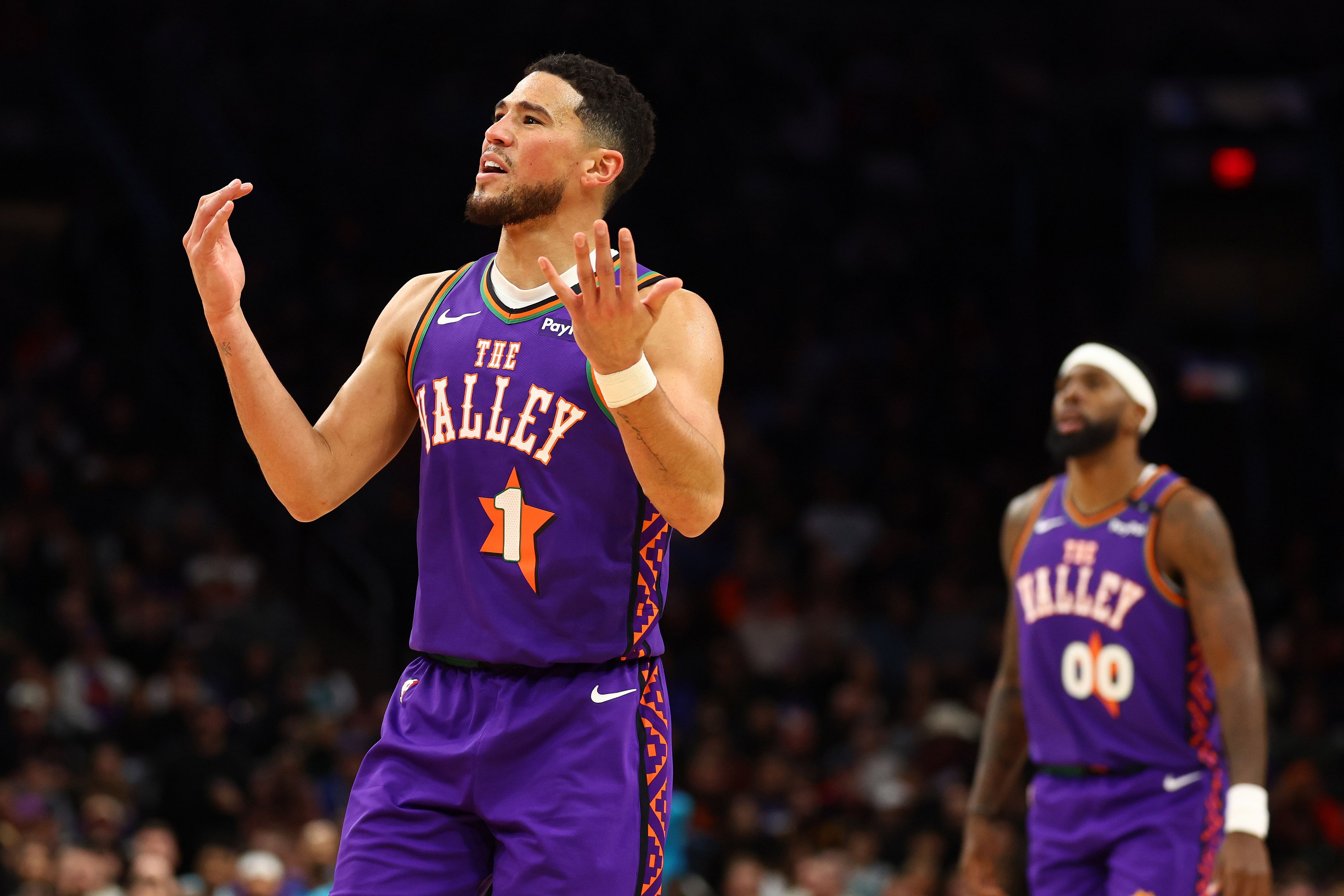 Phoenix Suns guard Devin Booker (1) reacts against the Charlotte Hornets during the first half - Source: Imagn