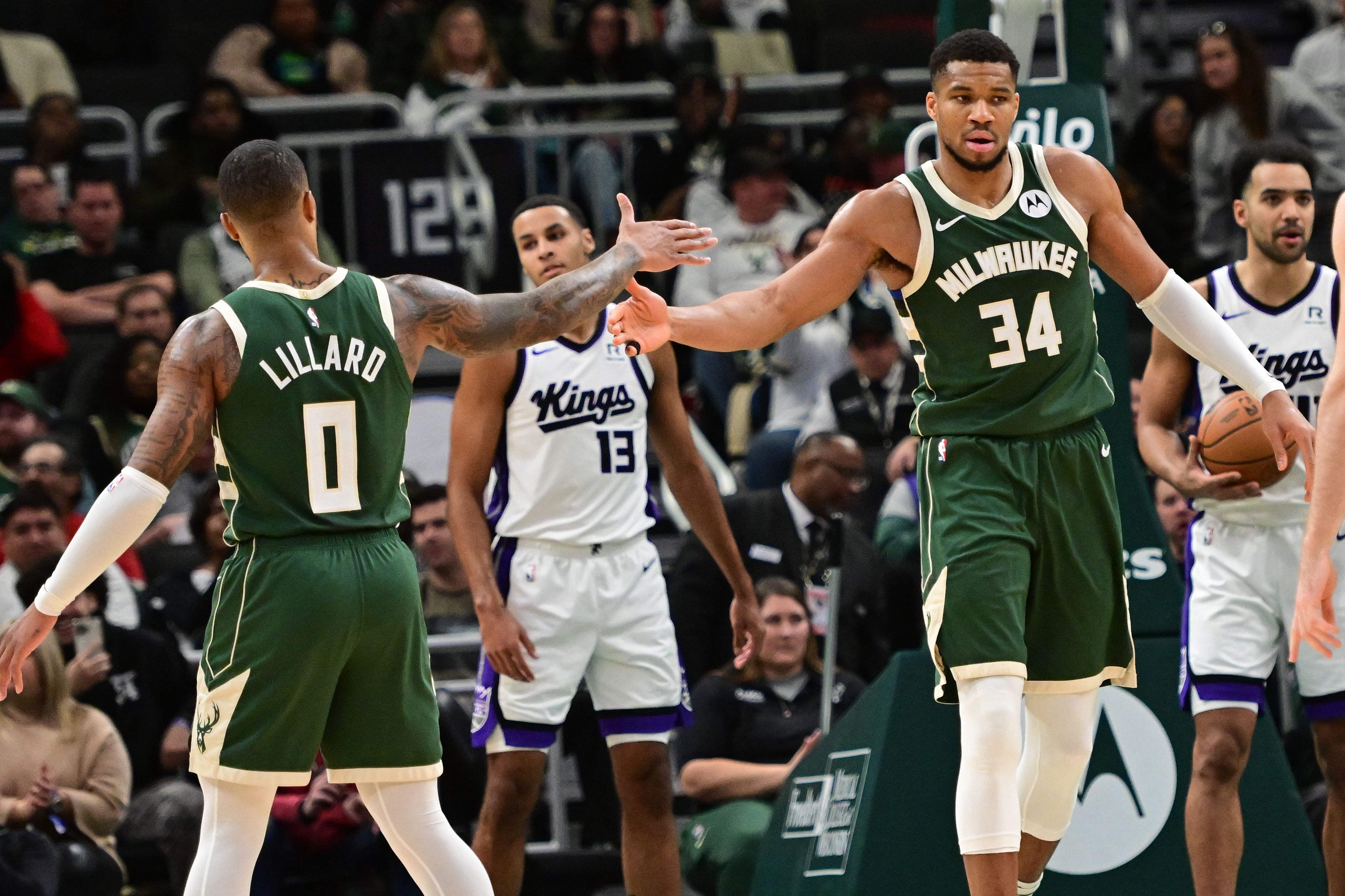 Milwaukee Bucks forward Giannis Antetokounmpo (34) reacts with guard Damian Lillard (0) after scoring a basket during an NBA game. (Credits: IMAGN)