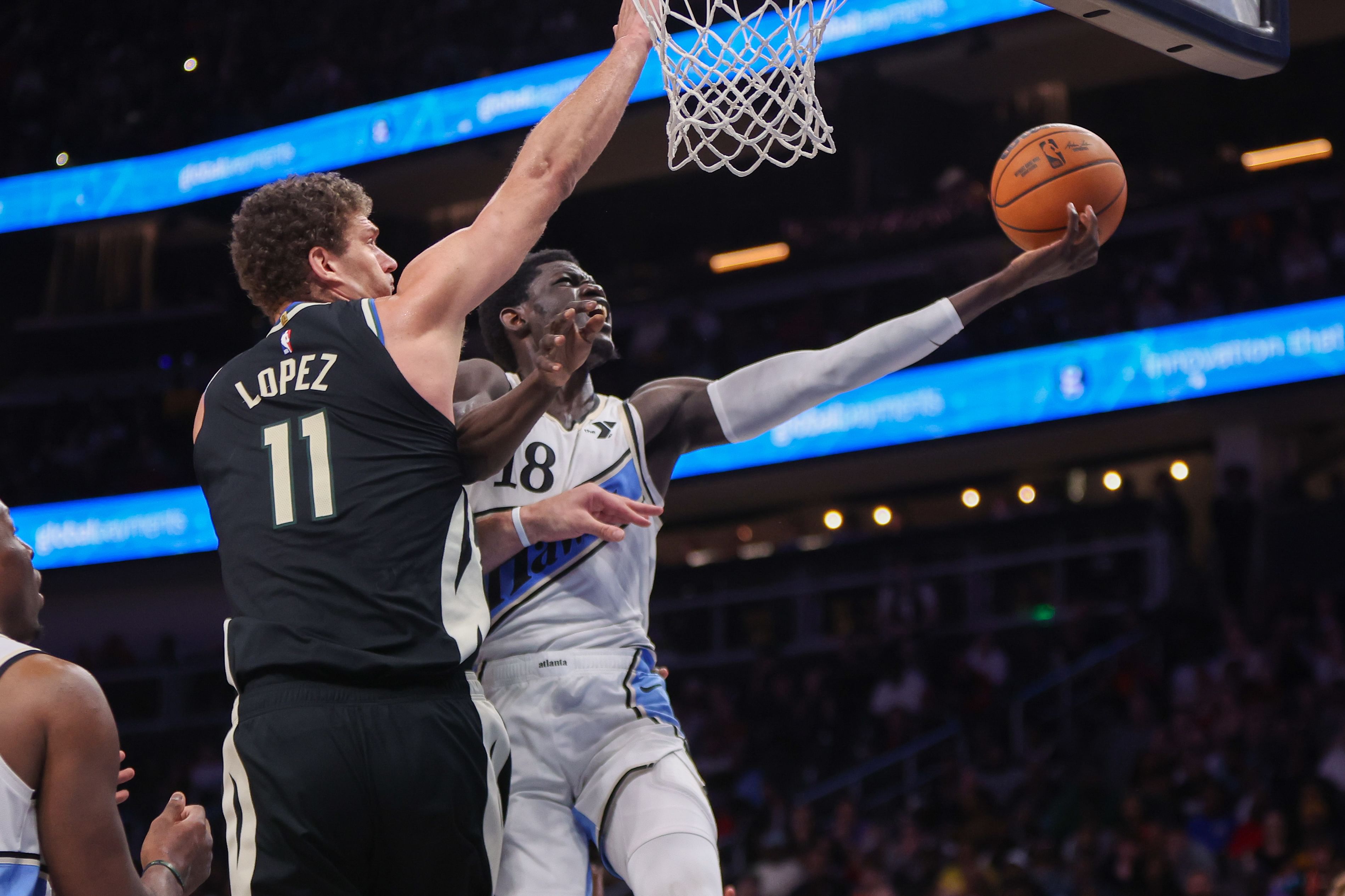 Feb 7, 2025; Atlanta, Georgia, USA; Atlanta Hawks forward Mouhamed Gueye (18) shoots past Milwaukee Bucks center Brook Lopez (11) in the fourth quarter at State Farm Arena. Mandatory Credit: Brett Davis-Imagn Images - Source: Imagn