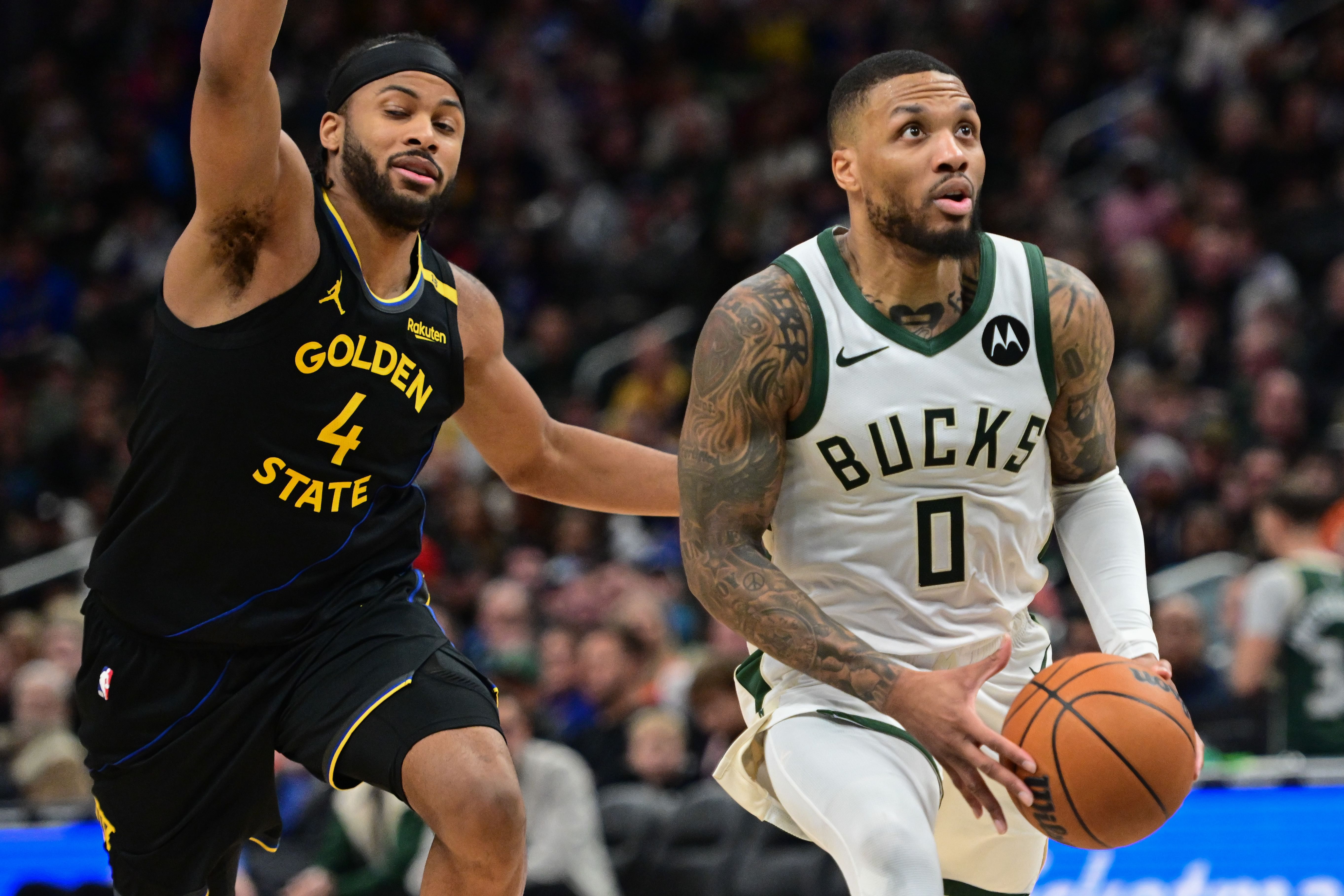 Milwaukee Bucks guard Damian Lillard looks for a shot against Golden State Warriors forward Moses Moody at Fiserv Forum. Photo Credit: Imagn