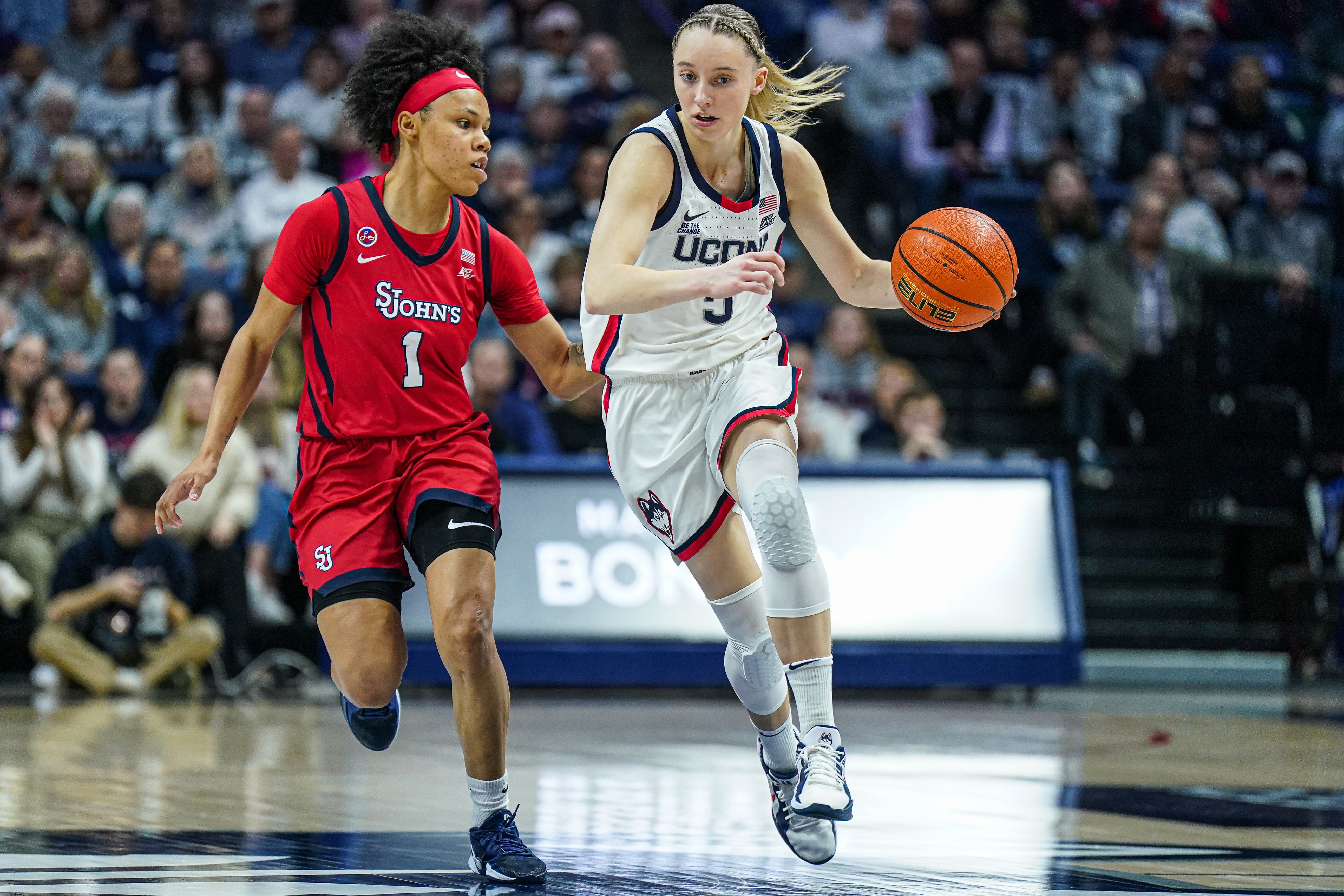 UConn Huskies guard Paige Bueckers returns the ball against St. John&#039;s Red Storm guard Ariana Vanderhoop at Harry A. Gampel Pavilion. Photo Credit: Imagn