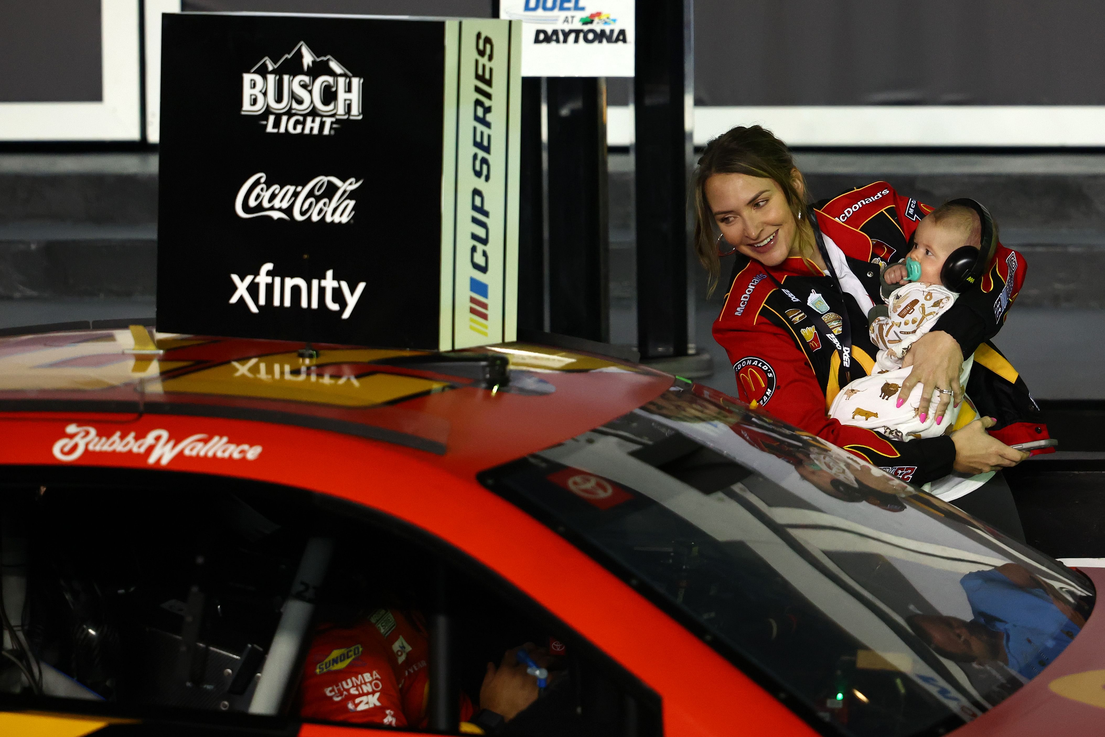 Bubba Wallace (in-car) celebrates with wife, Amanda Wallace, and son, Becks Hayden Wallace, in victory lane for Duel 1 at Daytona International Speedway - Source: Imagn