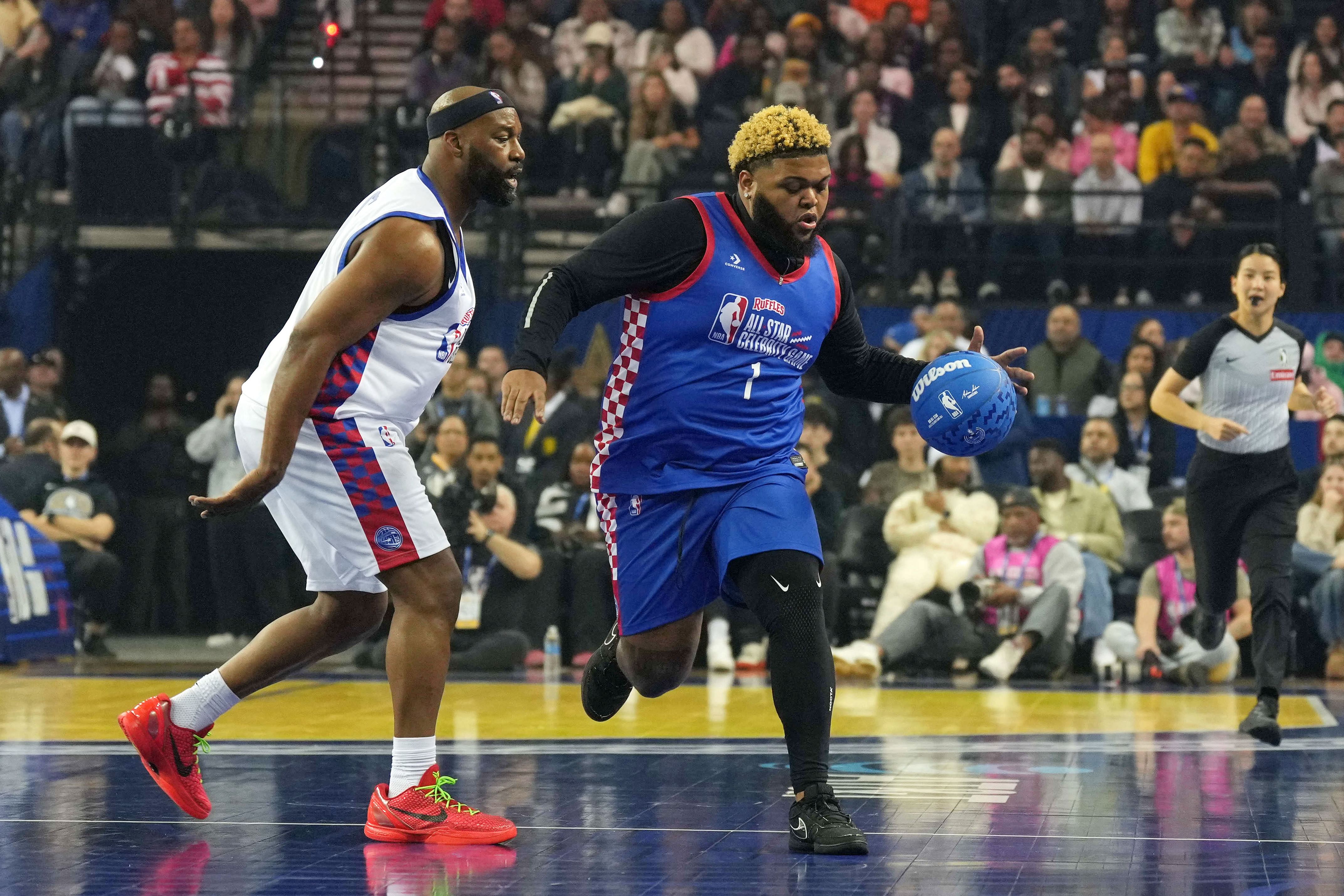 Druski of Team Rice dribbles the ball against Baron Davis of Team Bonds during the celebrity game at Oakland Arena. Photo Credits Imagn