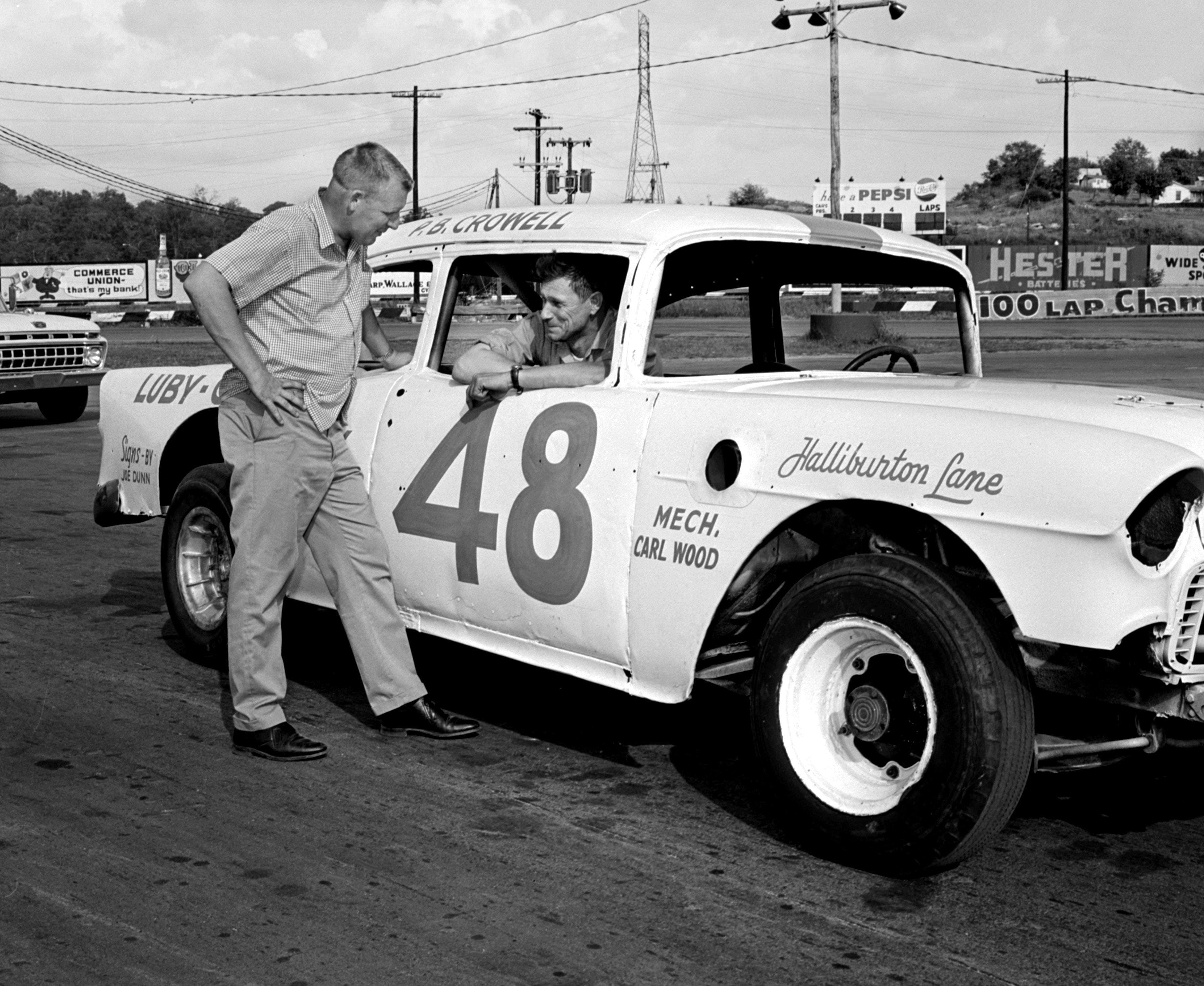 Driver P.B. Crowell sits in his race car at the Fairgrounds Speedway on Sept. 3, 1965 - Source: Imagn