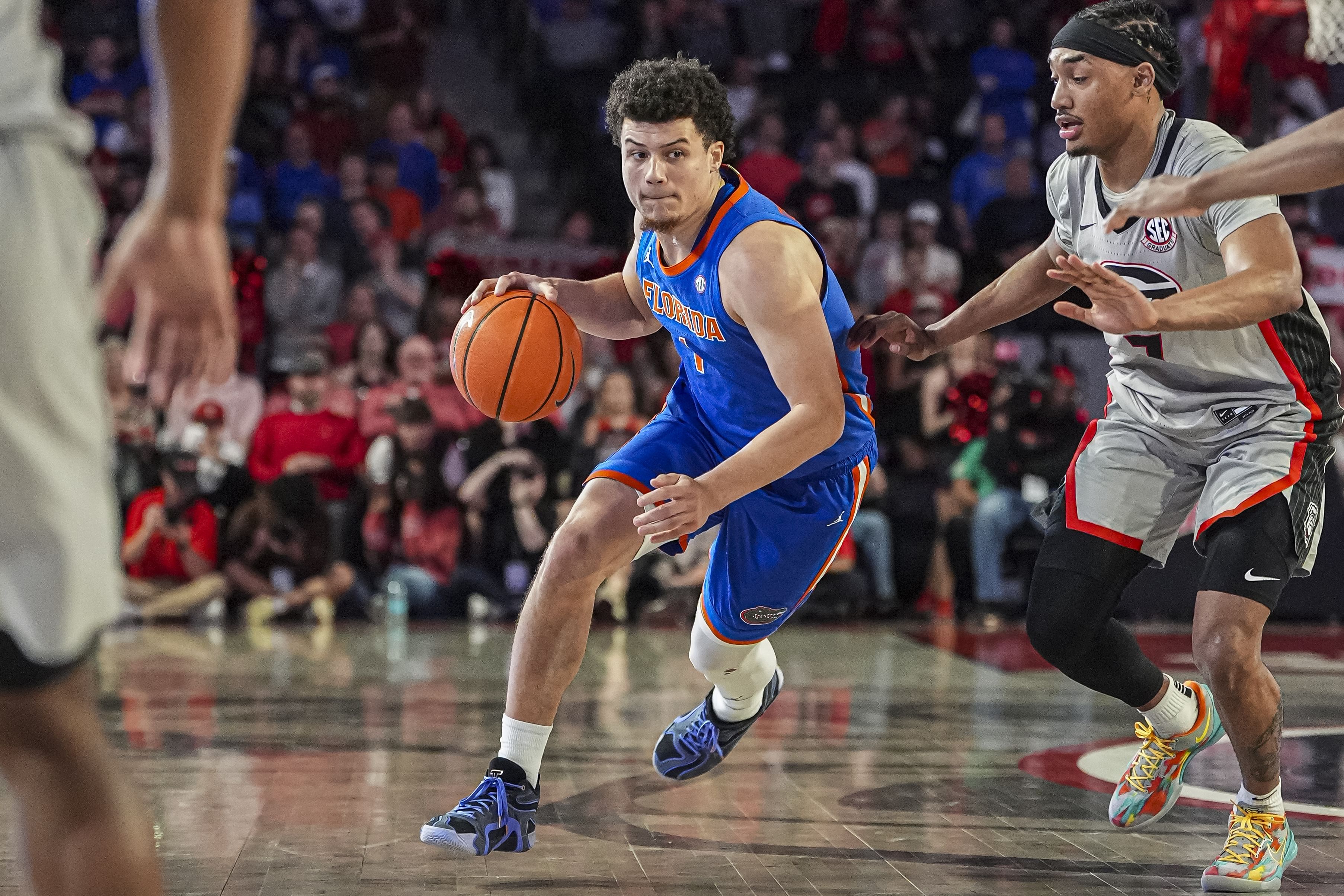 Florida Gators guard Walter Clayton Jr. (#1) dribbles past Georgia Bulldogs guard Tyrin Lawrence (#7) during the second half at Stegeman Coliseum. Clayton is a finalist for the Bob Cousy Award. Photo: Imagn