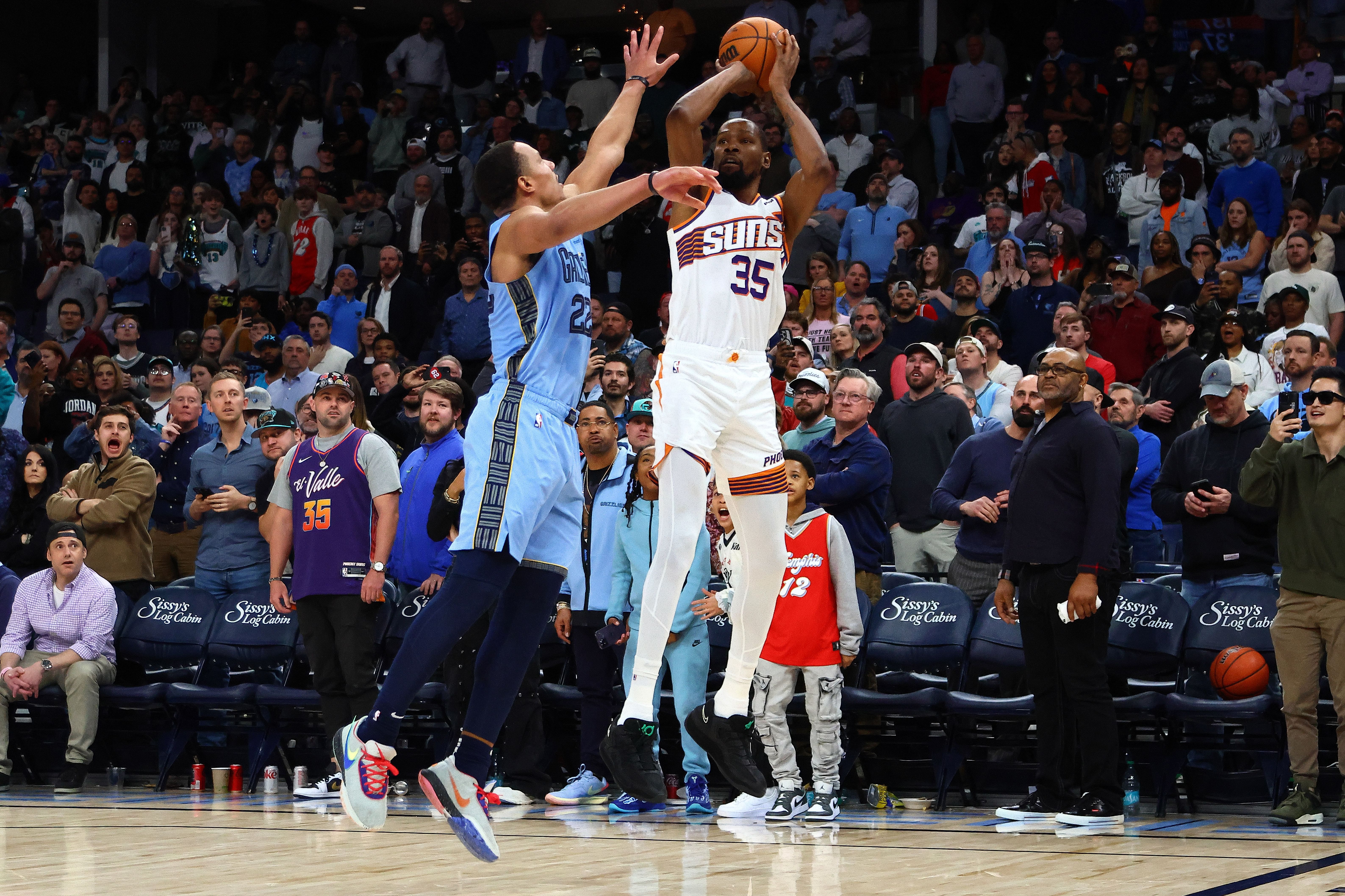 Feb 25, 2025; Memphis, Tennessee, USA; Phoenix Suns forward Kevin Durant (35) shoots as Memphis Grizzlies guard Desmond Bane (22) defends as time expires during the fourth quarter at FedExForum. Mandatory Credit: Petre Thomas-Imagn Images - Source: Imagn