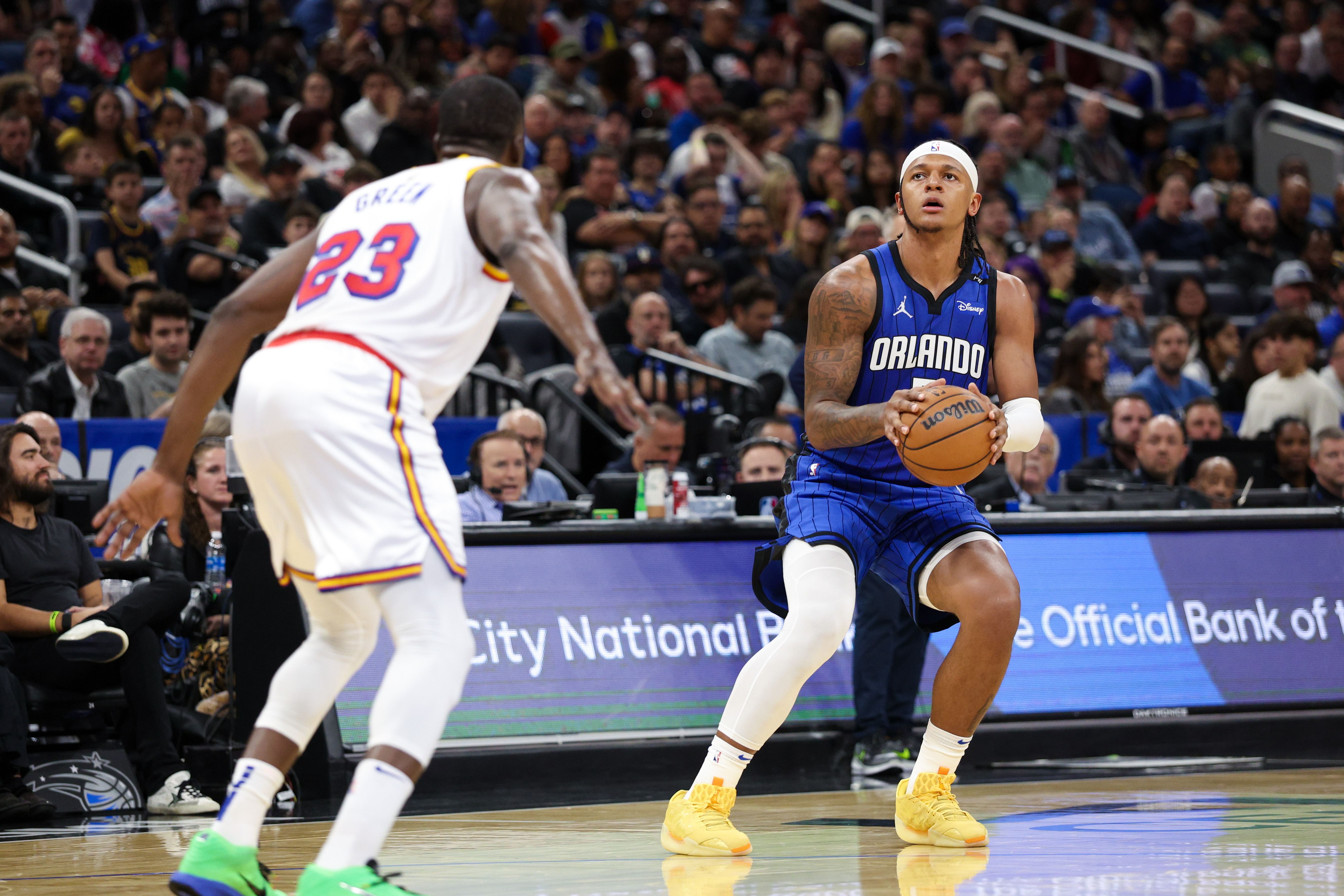 Paolo Banchero (5) shoots a 3-point shot against the Golden State Warriors in the second quarter at Kia Center. Mandatory Credit: Nathan Ray Seebeck-Imagn Images