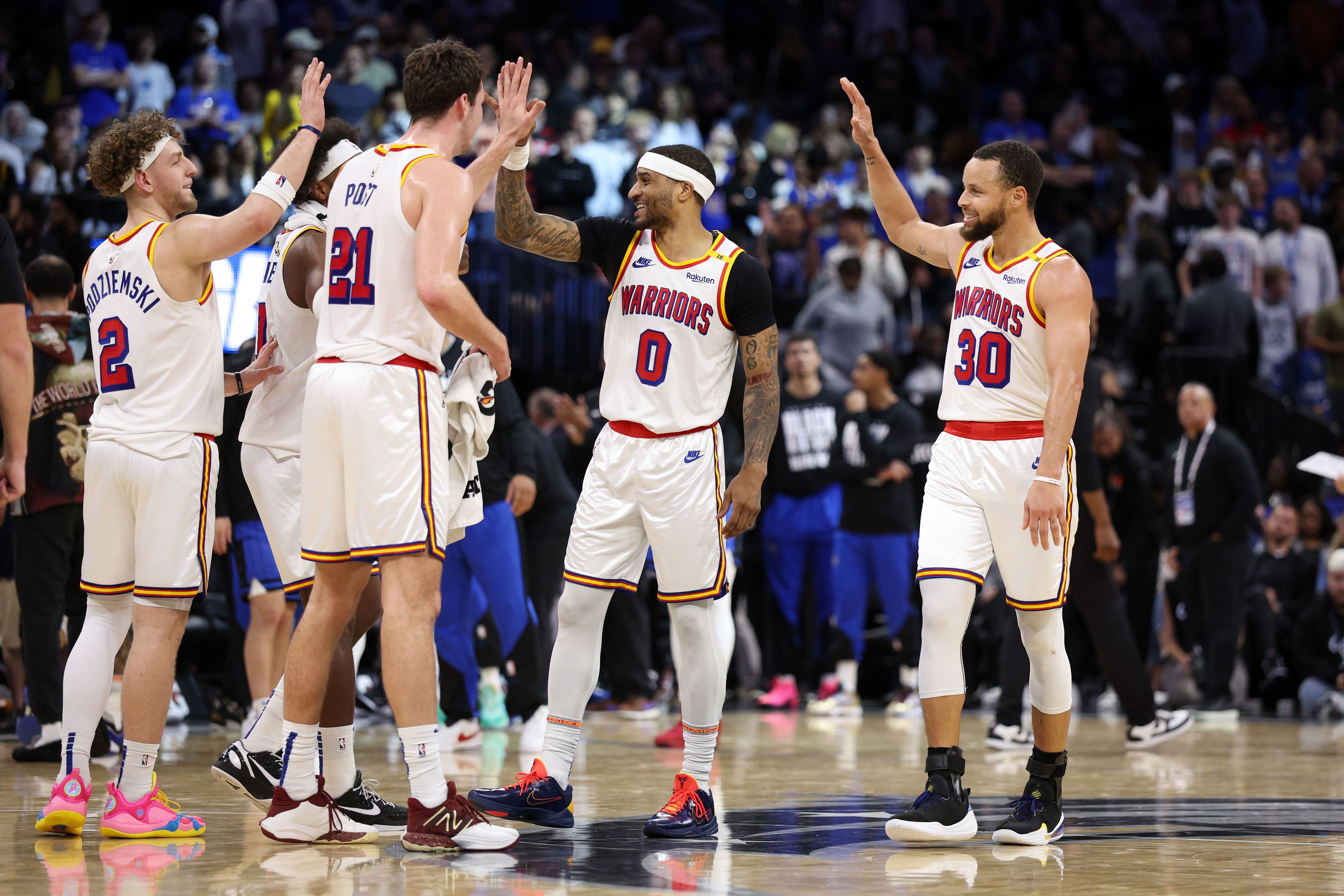 Golden State Warriors guard Stephen Curry (30) celebrates with guard Gary Payton II (0) center Quinten Post (21) after a play against the Orlando Magic in the fourth quarter at Kia Center. Mandatory Credit: Nathan Ray Seebeck-Imagn Images - Source: Imagn