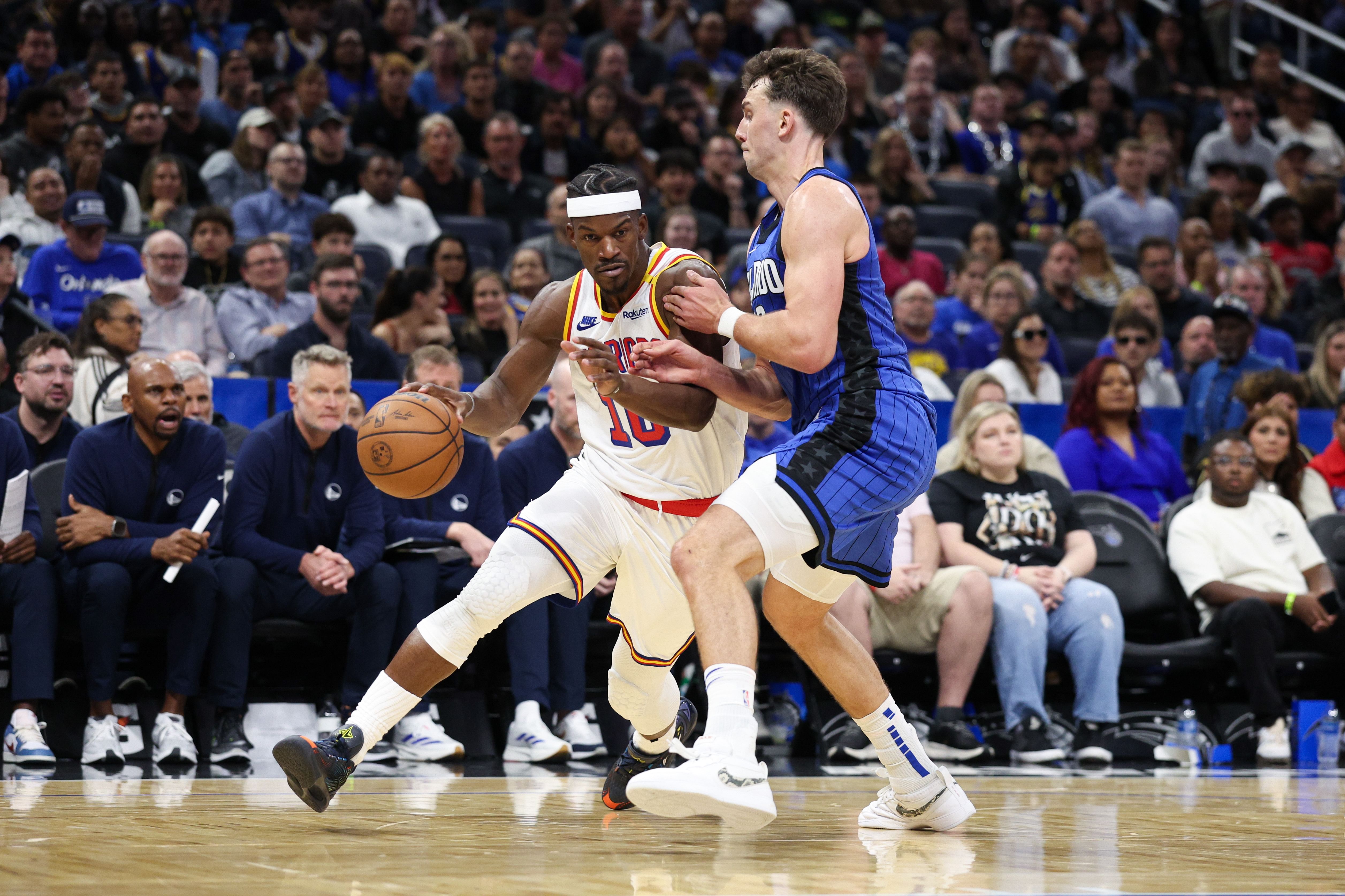 Feb 27, 2025; Orlando, Florida, USA; Golden State Warriors forward Jimmy Butler III (10) is guarded by Orlando Magic forward Franz Wagner (22) in the fourth quarter at Kia Center. Mandatory Credit: Nathan Ray Seebeck-Imagn Images - Source: Imagn